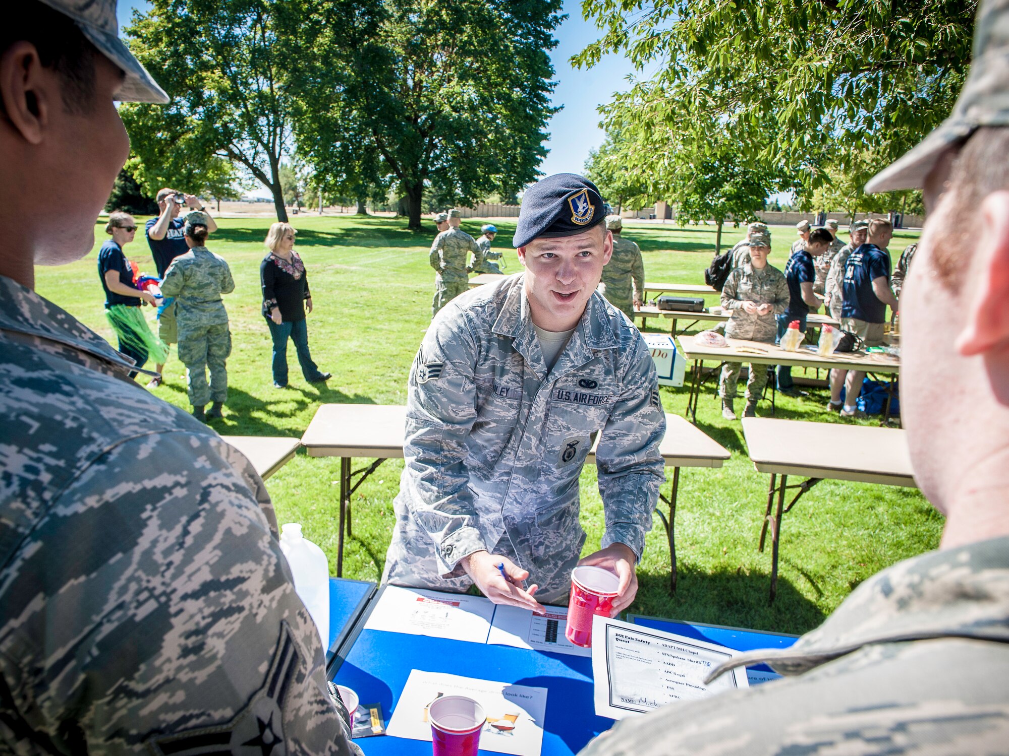 Senior Airman Tim Riley, 92nd Security Forces Squadron police services program manager, explains the importance of understanding what’s considered an average shot and what one of these drinks actually looks like during the DUI Fair at Fairchild Air Force Base, Washington, Sept. 5, 2014. DUIs are a concern across the Air Force and the statistics show it doesn’t seem to be getting better. Events like these allowed the nearly 100 Airmen an opportunity to experience a simulated drunken state safely and under the guidance of security forces and Team Fairchild’s locally run Air Force Drug and Alcohol Abuse Program. (U.S. Air Force photo by Staff Sgt. Benjamin W. Stratton/Released)