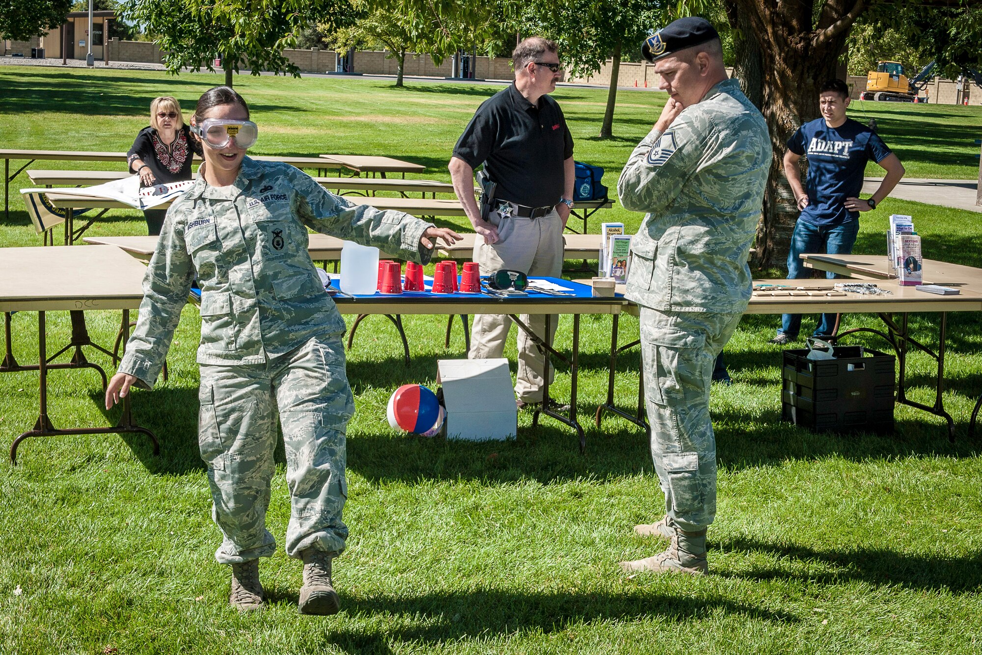 Tech. Sgt. Moriah Washburn, 92nd Security Forces Squadron physical security NCO, experiences a field sobriety test as Master Sgt. Chris Pepperman, 92nd SFS installation security NCO in charge, evaluates her performance during the DUI Fair at Fairchild Air Force Base, Washington, Sept. 5, 2014. DUIs are a concern across the Air Force and the statistics show it doesn’t seem to be getting better. Events like these allow Airmen to experience a simulated drunken state safely and under the guidance of security forces and Team Fairchild’s locally run Air Force Drug and Alcohol Abuse Program. Nearly 100 Participants were able to experience beer goggles during a field sobriety test, speak with legal and security forces representatives and take control of the impaired and distracted driving simulator. (U.S. Air Force photo by Staff Sgt. Benjamin W. Stratton/Released)