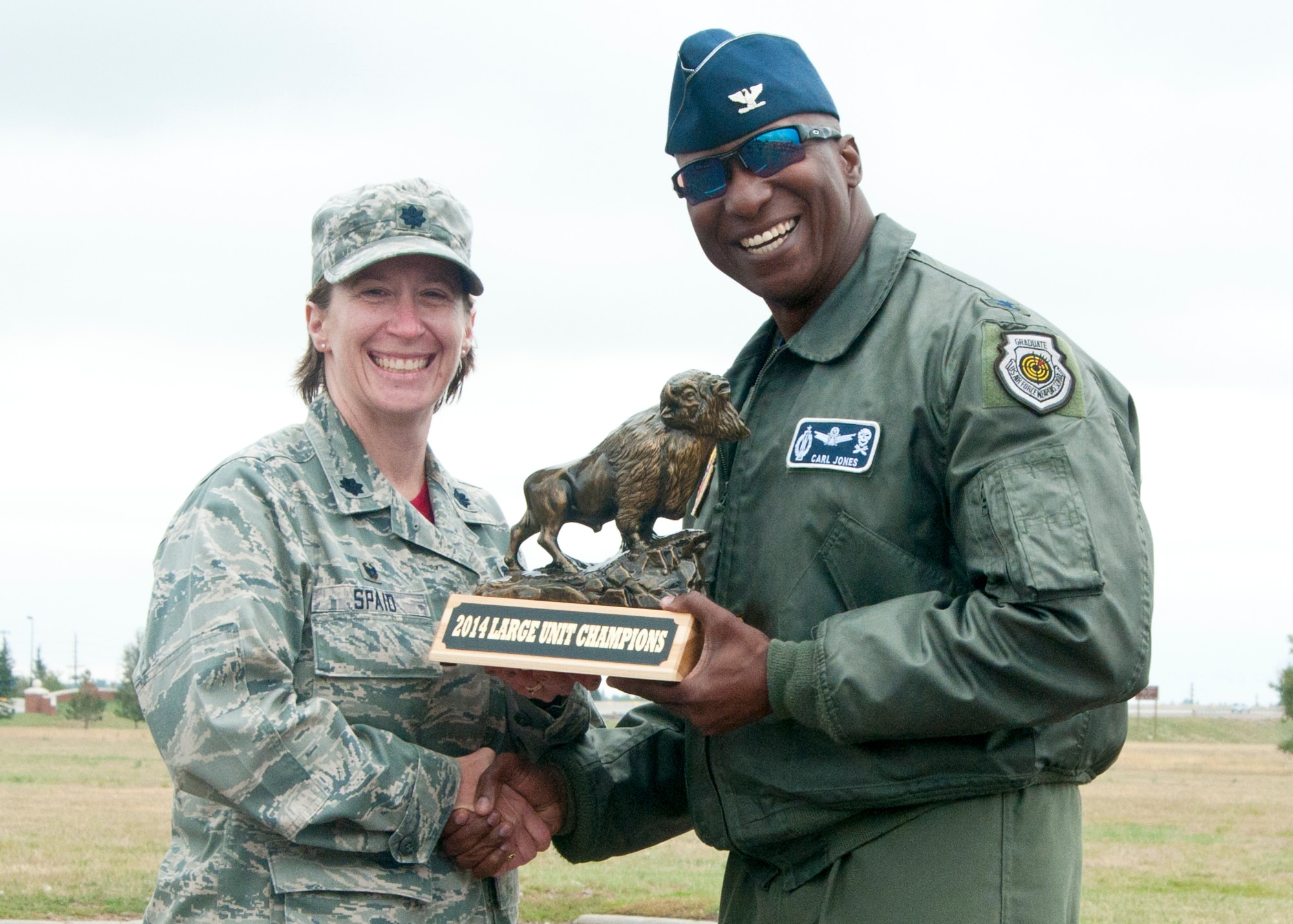Col. Carl Jones, 90th Missile Wing vice commander, presents Lt. Col. Penny Spaid, 90th Medical Operations Squadron commander, with the 2014 Large Unit Champions award Sept. 5, 2014, for the 90th Medical Group’s success in the previous week’s Frontiercade. This marks the 90th MDG’s third consecutive win for Frontiercade. (U.S. Air Force photo by Airman Malcolm Mayfield)
