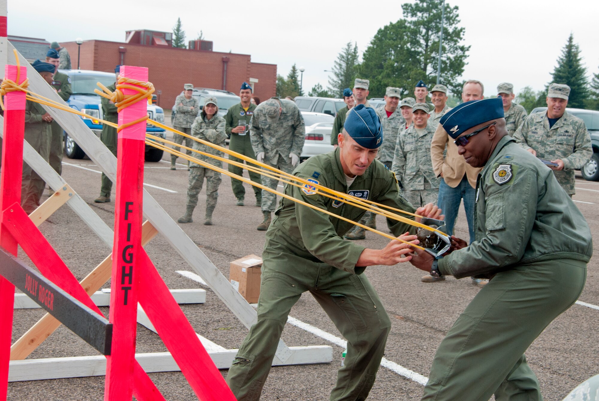 Col. Carl Jones, 90th Missile Wing vice commander, and Capt. Austin Winner, 90th MW executive officer, loads their launcher for the Buffalo Chip Toss Sept. 5, 2014, outside of the Trail’s End Club. The Buffalo Chip Toss was rescheduled due to rain during Frontiercade. (U.S. Air Force photo by Airman Malcolm Mayfield)