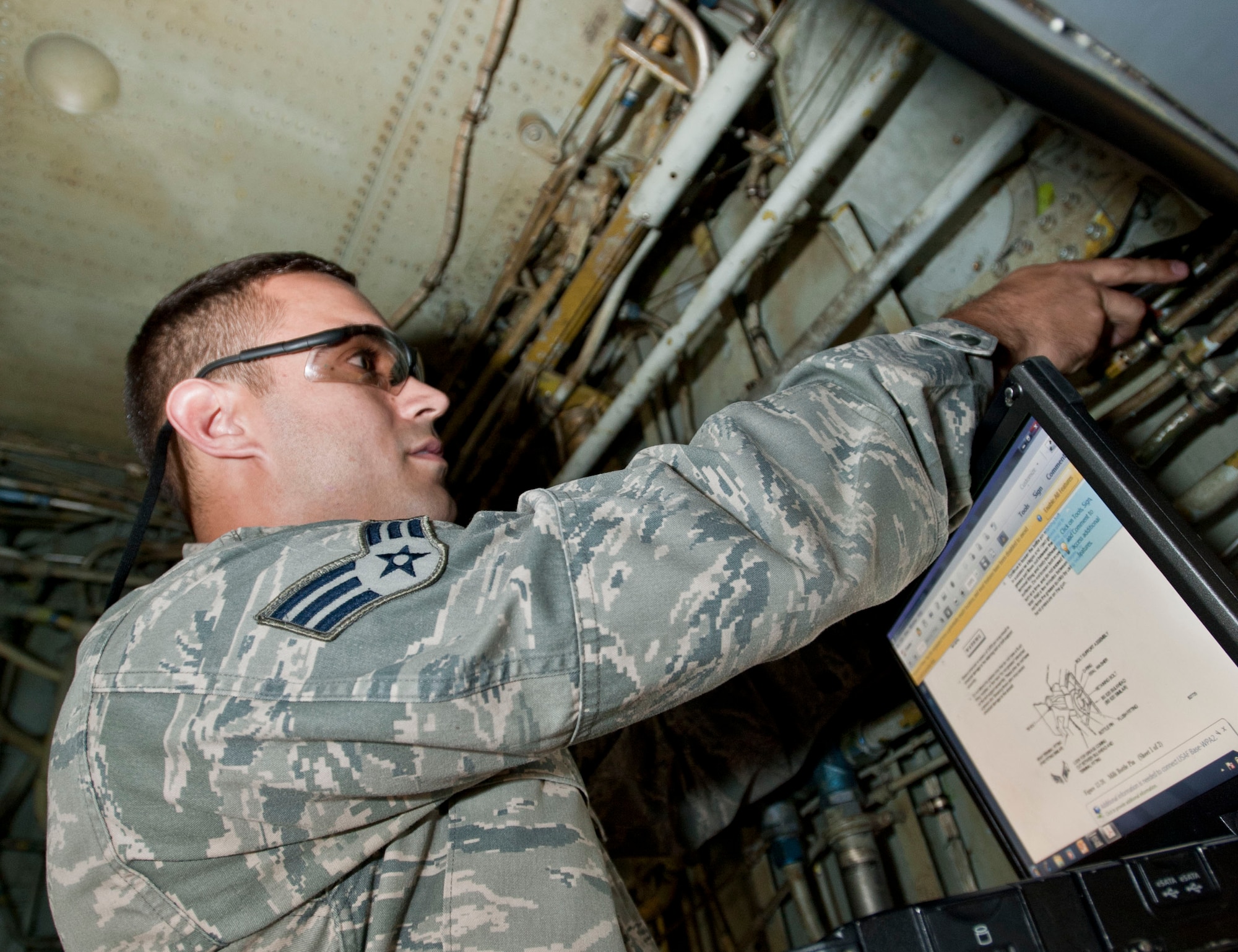Senior Airman Kyle Cervi, 92nd Maintenance squadron Periodic inspection crew chief, secures a milk bottle pin with a safety wire on a KC-135 Stratotanker Sept. 5, 2014, at Fairchild Air Force Base, Washington. Cervi has been selected as a member of Team Fairchild’s elite, Fairchild’s Finest.  (U.S. Air Force photo by Staff Sgt. Veronica Montes/Released)