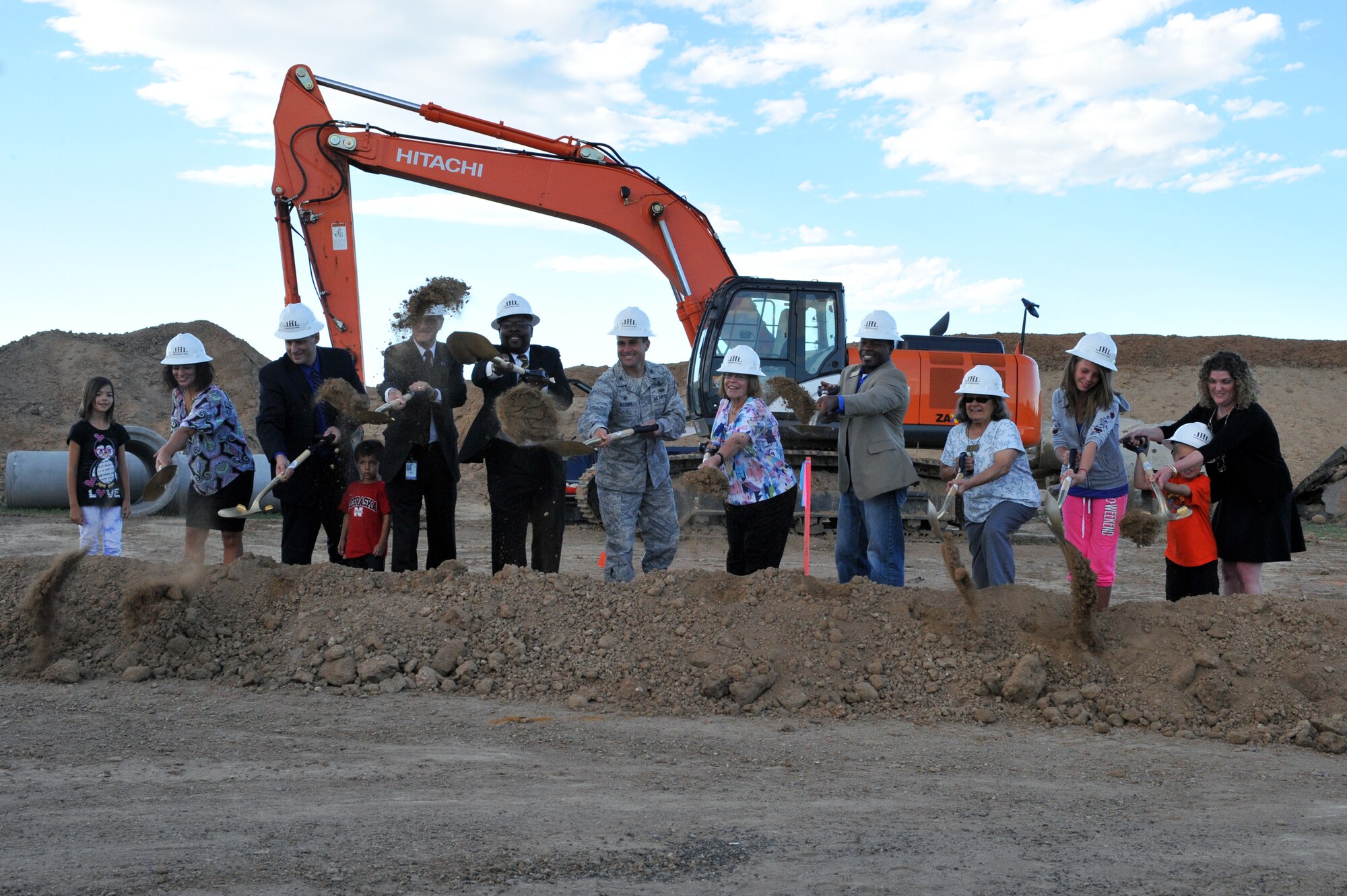 Students, parents, and base and community leaders break ground at the Aurora Public Schools Community Campus P-8 groundbreaking ceremony Sept. 3, 2014, in Aurora, Colorado. The new school will be just outside of Buckley’s fence, benefitting the families and students of Team Buckley. (U.S. Air Force photo by Airman Emily E. Amyotte/Released)