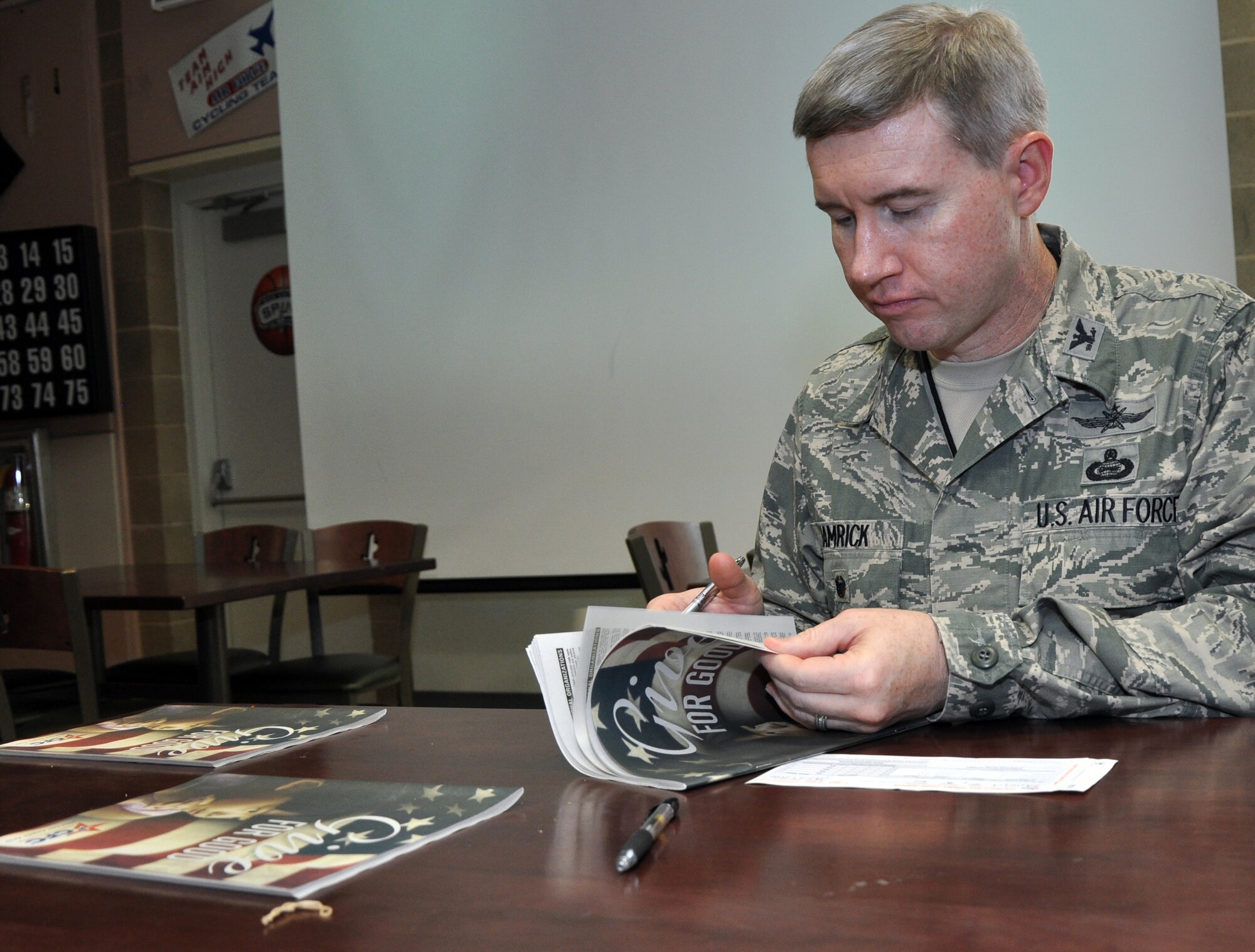 GOODFELLOW AIR FORCE BASE, Texas – Col. Terry J. Hamrick Jr., 17th Training Wing Vice Commander, looks through the charities catalog at the Combined Federal Campaign kickoff at the Event Center Sept. 2. The book features more than 24,000 CFC charities raising money for hunger, animals, diseases and other various causes. (U.S. Air Force photo/ Senior Airman Joshua Edwards)
