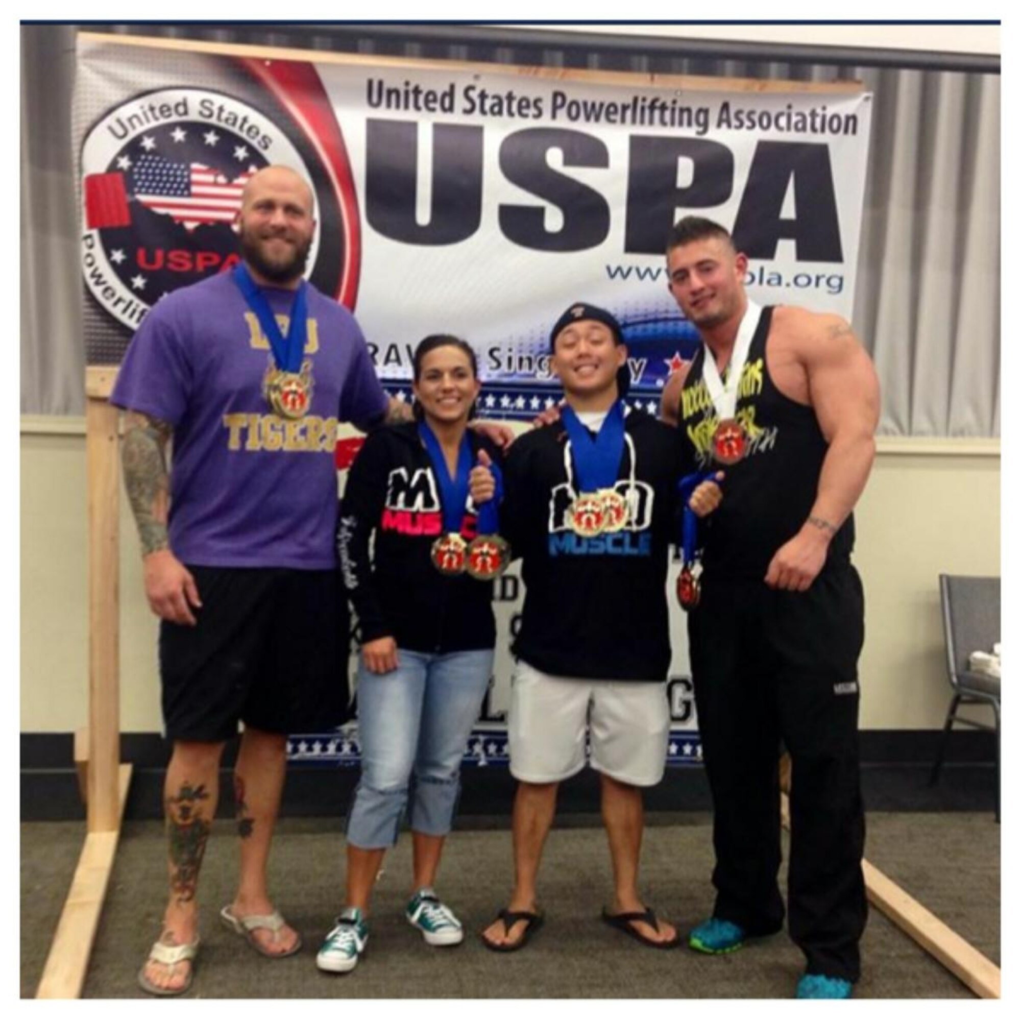 Airman 1st Class Benny Le, 22nd Security Forces Squadron entry controller, poses with his lifting team, Aug. 30, 2014, in El Dorado, Kan. Le competed in a regional powerlifting competition were he set multiple personal records and set the American bench press record for his weight class with a lift of 297 pounds. (Courtesy Photo)