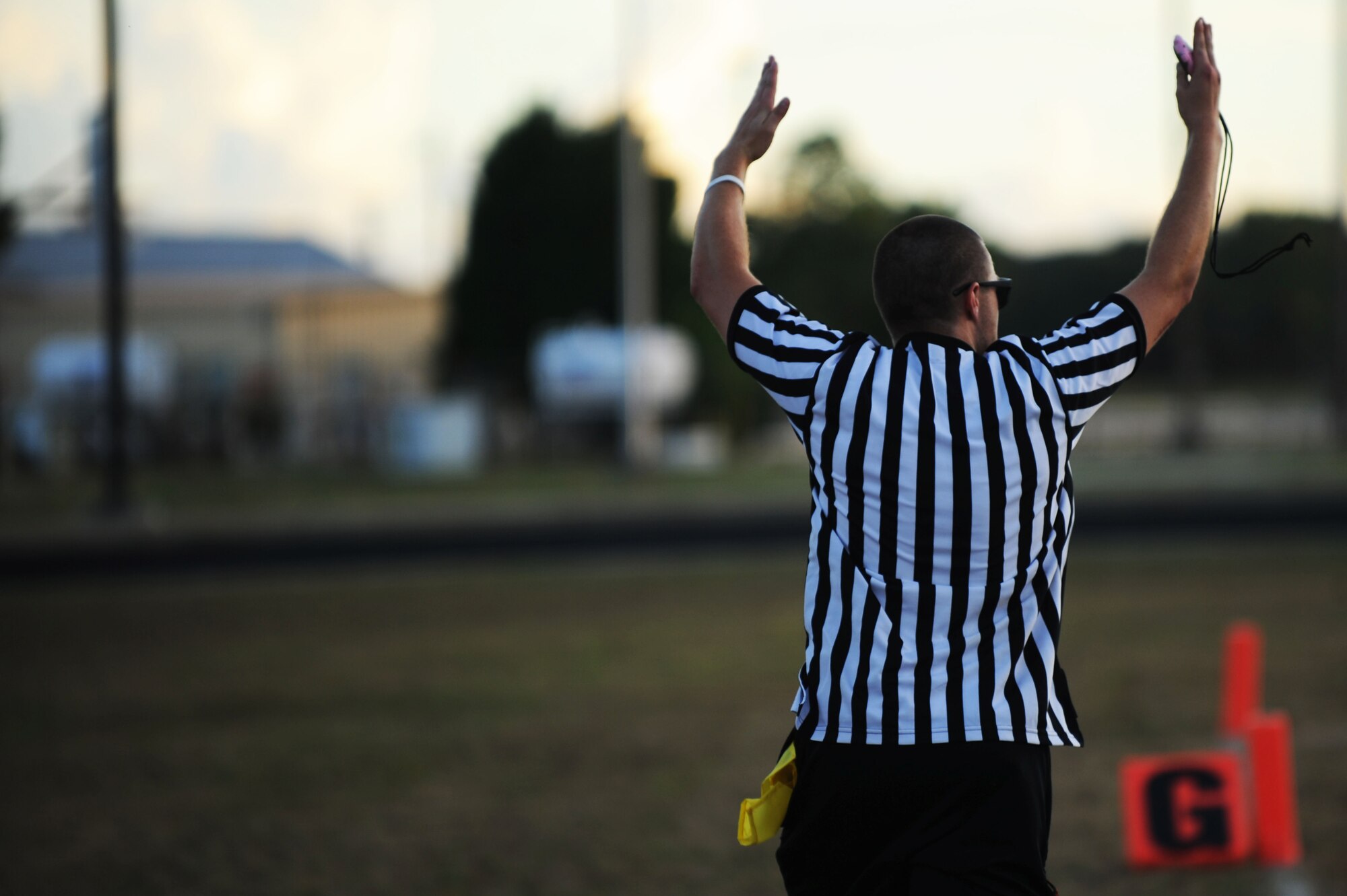 A referee signals a touchdown during an intramural flag football game at Shaw Air Force Base, S.C., Sept. 4, 2014. Each team participating in the league must have four volunteers scheduled to officiate games throughout the season. (U.S. Air Force photo by Airman 1st Class Michael Cossaboom/Released)