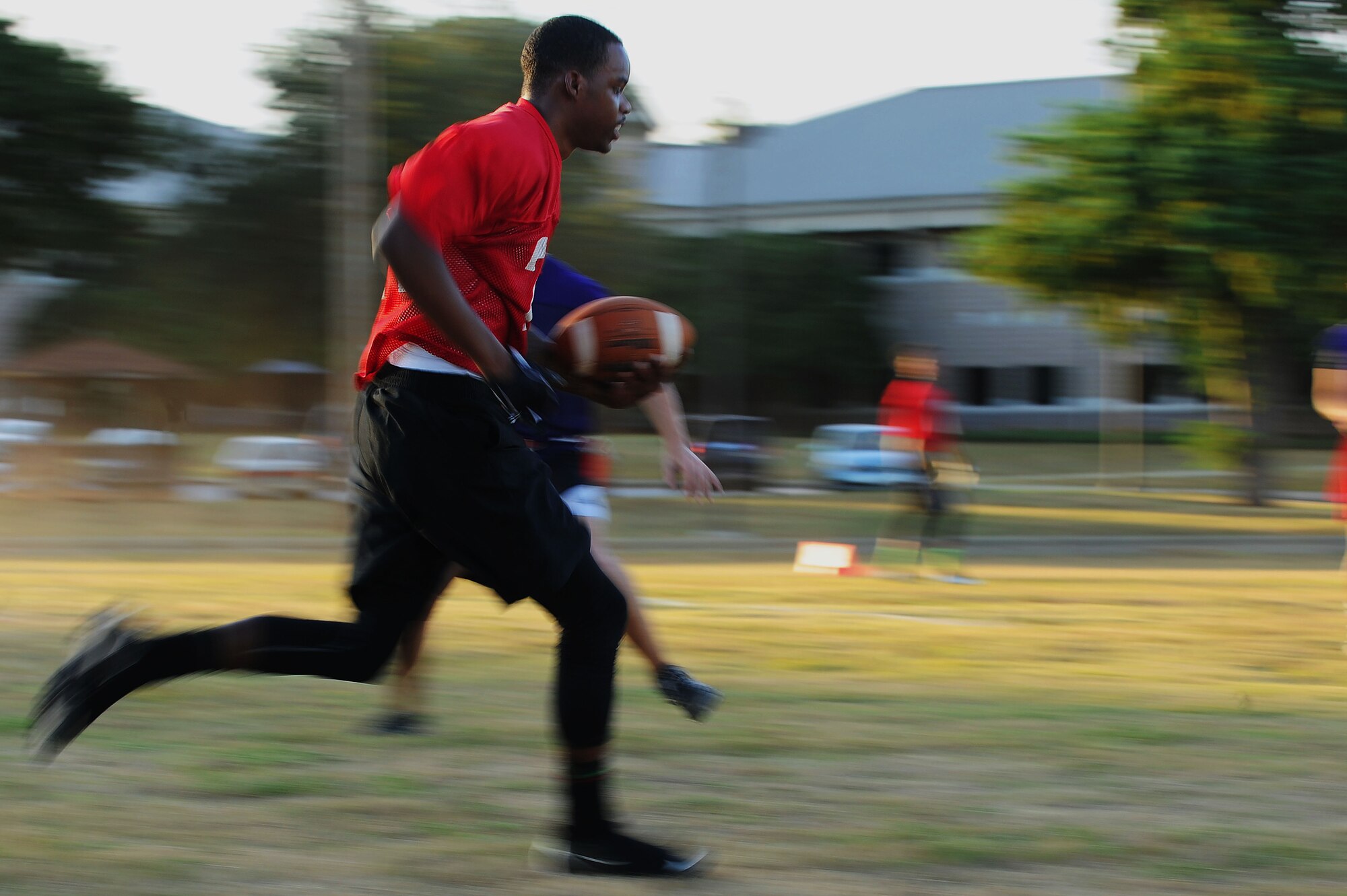 U.S. Air Force Senior Airman Nigel Scott, 20th Logistics Readiness Squadron equipment journeyman, runs down the sidelines during an intramural flag football game at Shaw Air Force Base, S.C., Sept. 4, 2014. Currently this season there are nine teams from around base. (U.S. Air Force photo by Airman 1st Class Michael Cossaboom/Released)