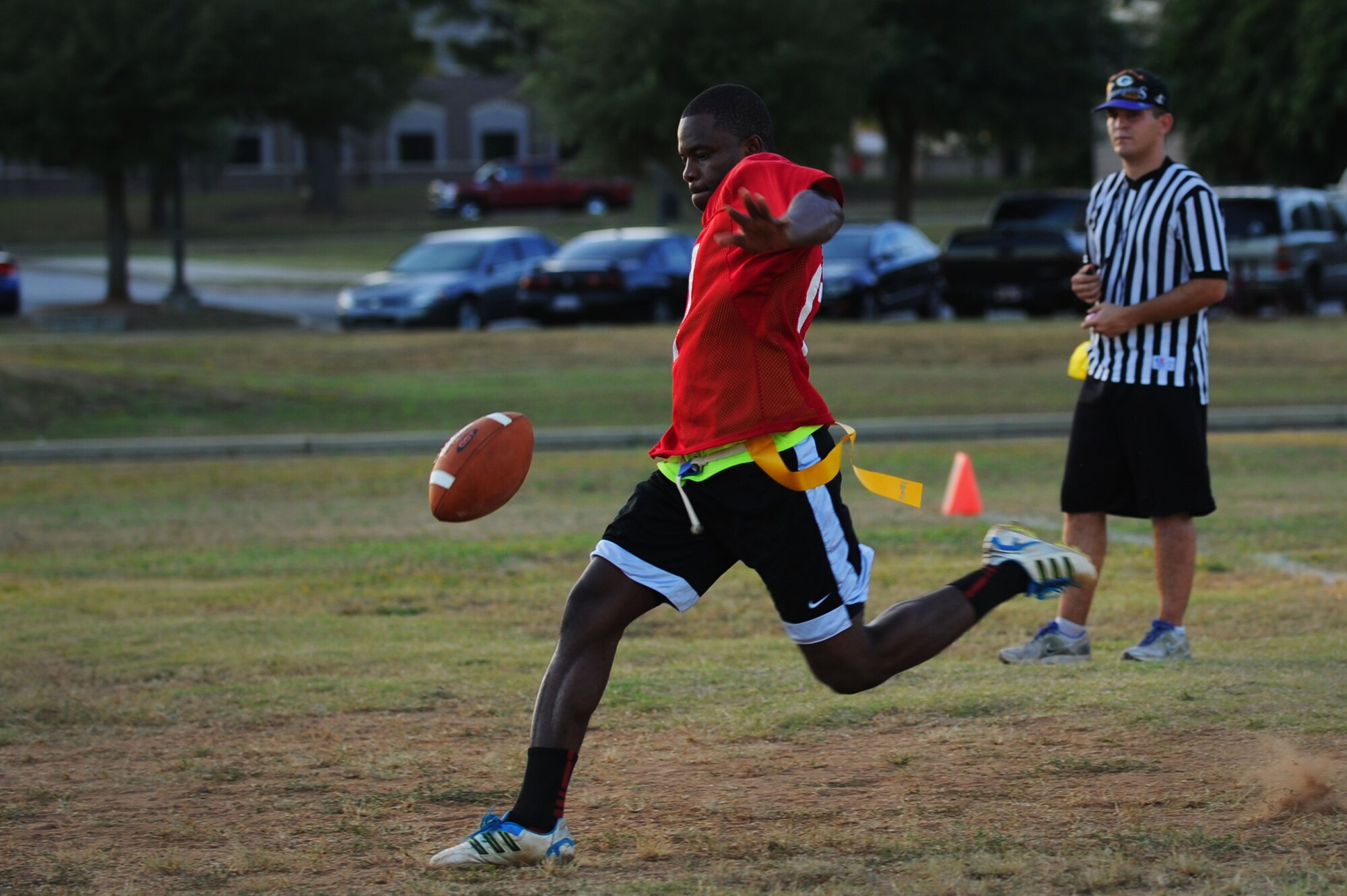 A member of the 20th Logistics Readiness Squadron’s intramural flag football team punts the ball during the game at Shaw Air Force Base, S.C., Sept. 4, 2014. Intramural sports are an Air Force wide program, governed by Air Force Instruction 34-266. (U.S. Air Force photo by Airman 1st Class Michael Cossaboom/Released)