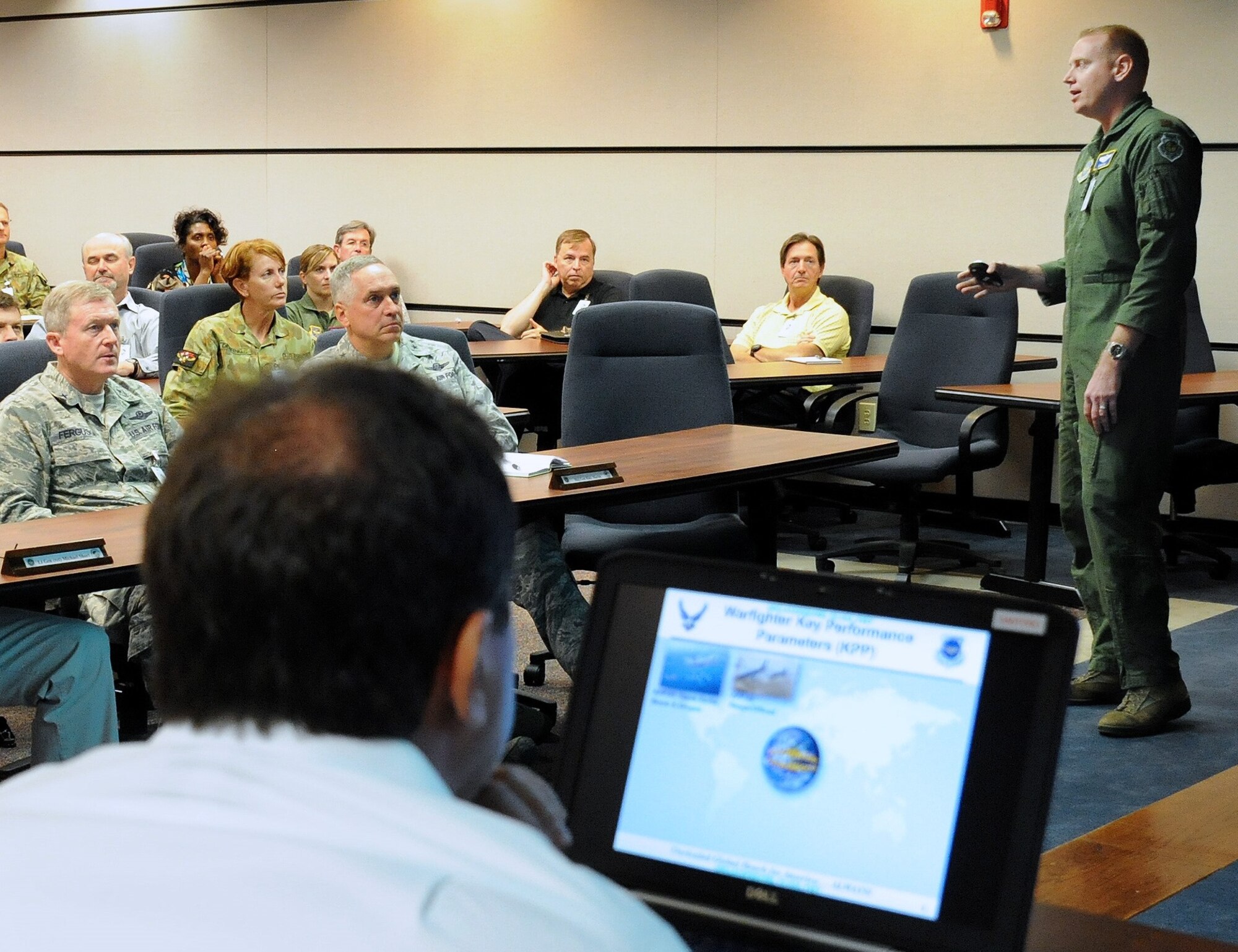 Maj. Darrin Dial, Air Mobility Command A3, presents a briefing about the KC 46A, the Air Force's new tanker expected to be in the inventory within ten years, to  Maj. Gen. Frederick Martin (right), USAF Expeditionary Center commander and Brig. Gen. Gregory Ferguson, Director of Mobility Forces (left) and the GLOMO participants Aug. 26 at the Expeditionary Center.  GLOMO tests AMC’s ability to support future mission requirements under an evolving scenario and valuates the forces, capabilities and platforms, including aircraft projected to be in the inventory, that AMC expects to be able to deliver to the warfighting commander ten years from now.  (U.S. Air Force photo/Danielle Brooks) 
