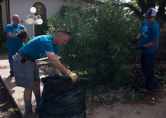 Colonel Robert Letourneau, 49th Materiel Maintenance Group commander, helps dispose of weeds at a local home during The Otero County Day of Caring in Alamagordo N.M., Sept. 5. The Day of Caring is an event sponsored by the United Way of Otero County. Volunteers from Holloman and the local community perform various tasks for individuals who are unable to accomplish the tasks or cannot afford to have the work done. Such tasks include fixing their homes, yards or other facilities, while also creating a strong relationship between Team Holloman and the surrounding communities. (U.S. Air Force photo by Senior Airman Leah Ferrante/Released)