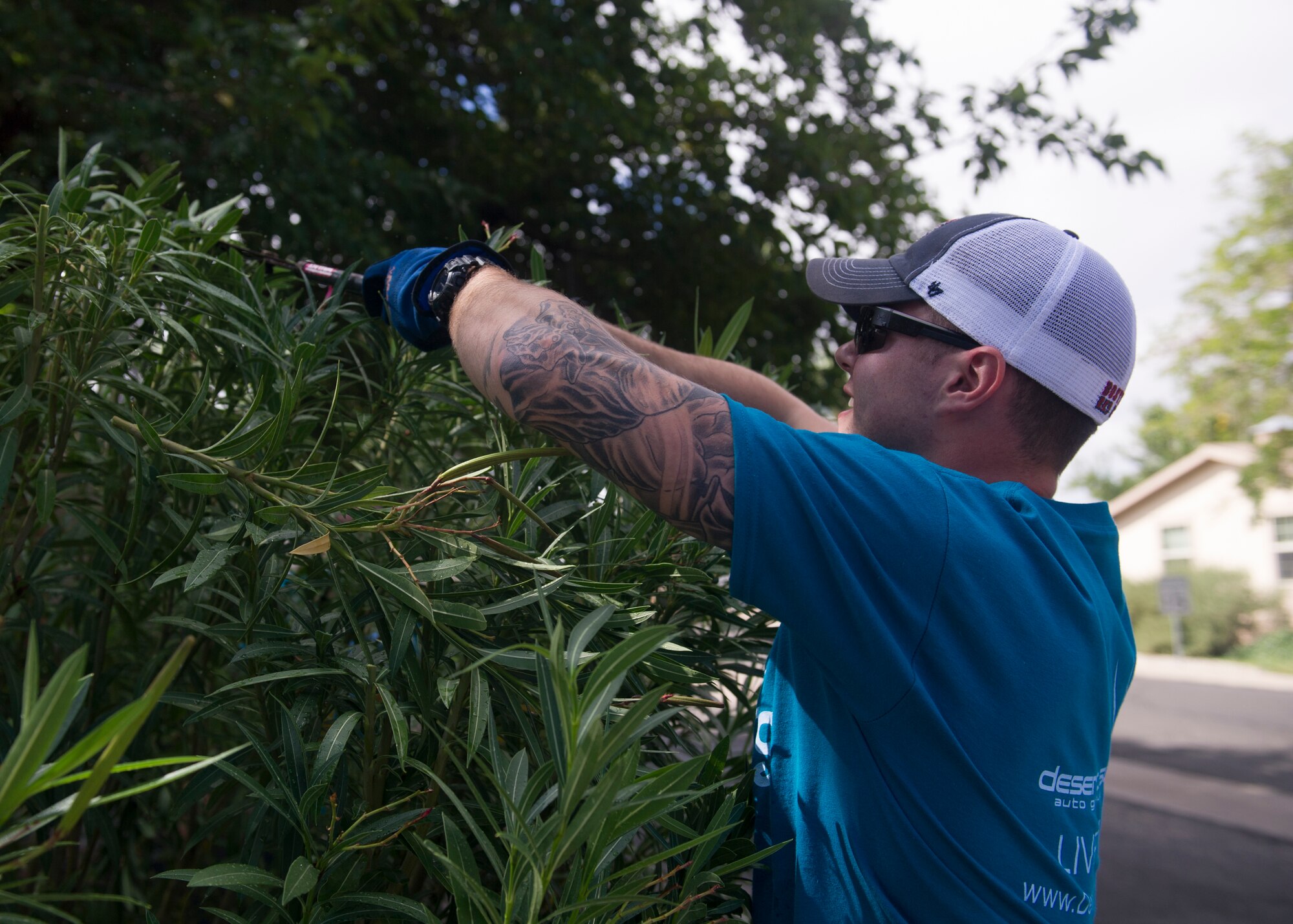 Senior Airman Taylor Vondrasek, 49th Materiel Maintenance Support Squadron structural journeyman, cuts down hedges at a local home during The Otero County Day of Caring in Alamagordo N.M., Sept. 5. The Day of Caring is an event sponsored by the United Way of Otero County. Volunteers from Holloman and the local community perform various tasks for individuals who are unable to accomplish the tasks or cannot afford to have the work done. Such tasks include fixing their homes, yards or other facilities, while also creating a strong relationship between Team Holloman and the surrounding communities. (U.S. Air Force photo by Senior Airman Leah Ferrante/Released)