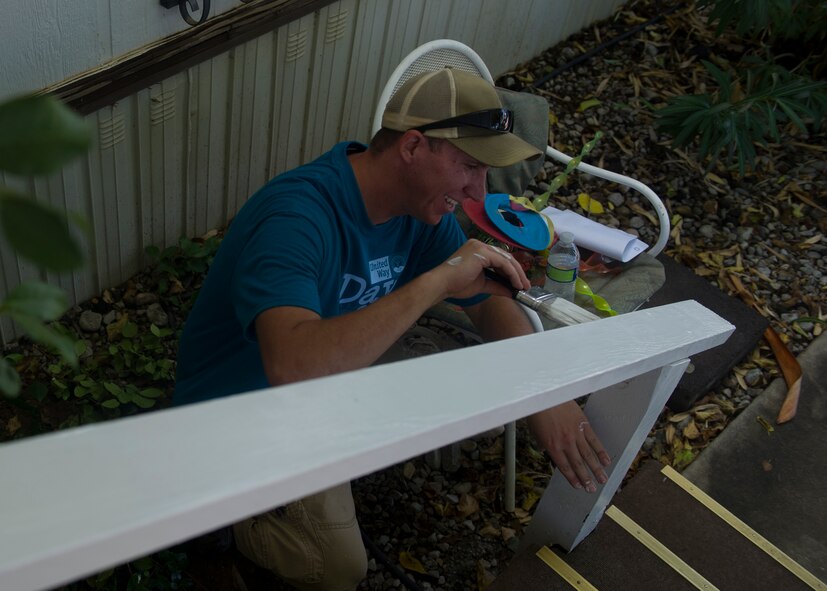 Airman 1st Class Lucian Root, 49th Materiel Maintenance Support Squadron structural journeyman, paints railings of a home during The Otero County Day of Caring in Alamagordo N.M., Sept. 5. The Day of Caring is an event sponsored by the United Way of Otero County. Volunteers from Holloman and the local community perform various tasks for individuals who are unable to accomplish the tasks or cannot afford to have the work done. Such tasks include fixing their homes, yards or other facilities, while also creating a strong relationship between Team Holloman and the surrounding communities. (U.S. Air Force photo by Senior Airman Leah Ferrante/Released)