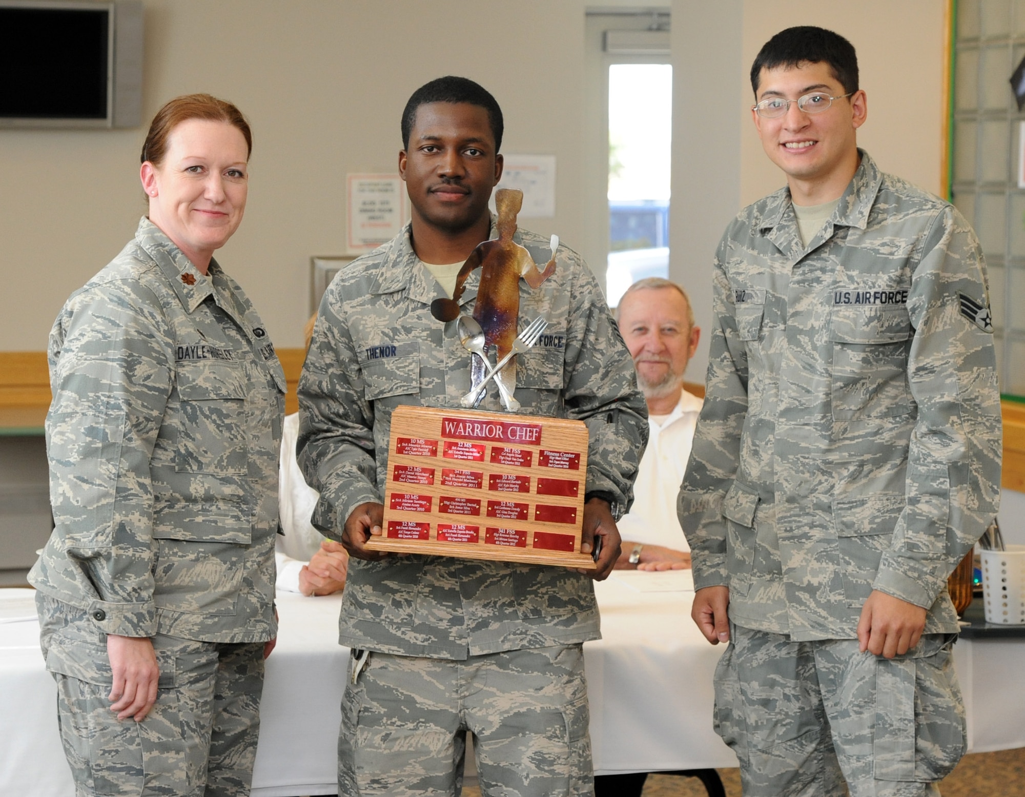 Maj. Karen Dayle-Horsley, 341st Force Support Squadron commander, poses with Staff Sgt. Ricardo Thenor and Senior Airman Justin Ruiz, representing the 341st FSS fitness center, following the team’s win at the Warrior Chef Sept. 4. Thenor and Ruiz’s main entrée was a raspberry salad, raspberry wild wings, and a raspberry lime smoothie. (U.S. Air Force photo/Airman 1st Class Joshua Smoot)