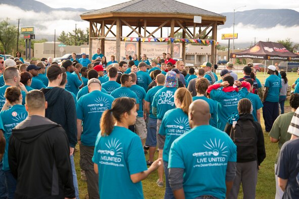 More than 600 members of Team Holloman gather for the opening ceremony of The Otero County Day of Caring in Alamagordo N.M., Sept. 5. The Day of Caring is an event sponsored by the United Way of Otero County. Volunteers from Holloman and the local community perform various tasks for individuals who are unable to accomplish the tasks or cannot afford to have the work done. Such tasks include fixing their homes, yards or other facilities, while also creating a strong relationship between Team Holloman and the surrounding communities. (U.S. Air Force photo by Airman 1st Class Chase Cannon/Released)