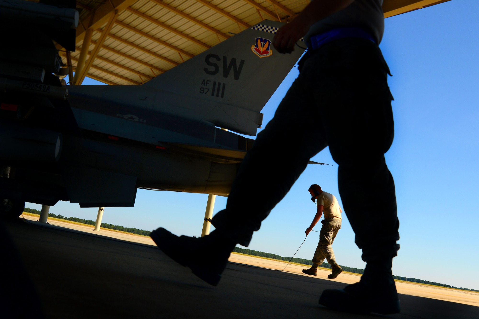 U.S. Air Force 20th Maintenance Group crew chiefs perform a final inspection on an F-16CM Fighting Falcon piloted by Royal Air Force Flight Lieutenant Benjamin Cable, 79th Fighter Squadron assistant director of operations, Aug. 27, 2014 at Shaw Air Force Base, S.C. Cable is officially assigned to the 79th FS via the Royal Air Force Exchange Officer program. If the squadron is tasked with a temporary duty assignment or deploys in support of a combat campaign, Cable would go with the unit and serve in the same role as his U.S. brothers and sisters. (U.S. Air Force photo by Staff Sgt. Kenny Holston/Released)