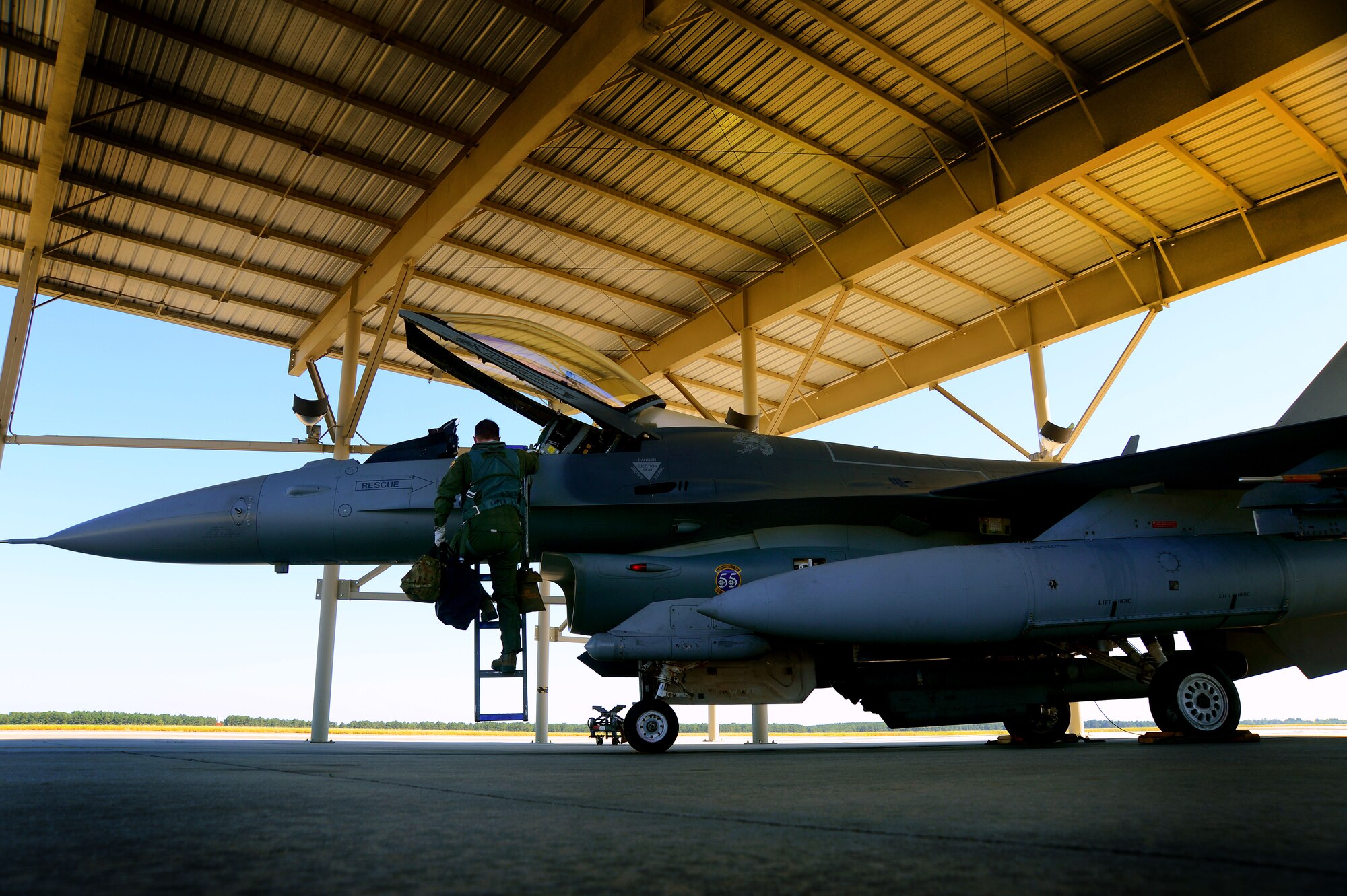 Royal Air Force Flight Lieutenant Benjamin Cable, 79th Fighter Squadron assistant director of operations, climbs into an F-16CM Fighting Falcon in preparation to fly, Aug. 27, 2014 at Shaw Air Force Base, S.C. Cable is a part of the Royal Air Force Exchange Officer program which is equivalent to the U.S. Air Force Military Personnel Exchange program. The program allows Cable to be assigned to the 79th FS and train with U.S. fighter pilots. (U.S. Air Force photo by Staff Sgt. Kenny Holston/Released)