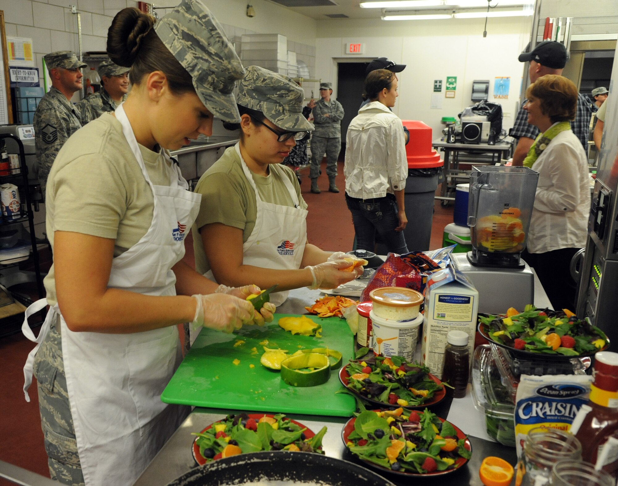Senior Airman Casey Bennett and Airman 1st Class Jenny Paeglow, 341st Force Support Squadron charlie flight chefs, prepare their dish during the Warrior Chef competition Sept. 4 at the Elkhorn Dining Facility. Contestants had 60 minutes to prepare and present their dishes to the judges for scoring. (U.S. Air Force photo/Airman 1st Class Joshua Smoot)
