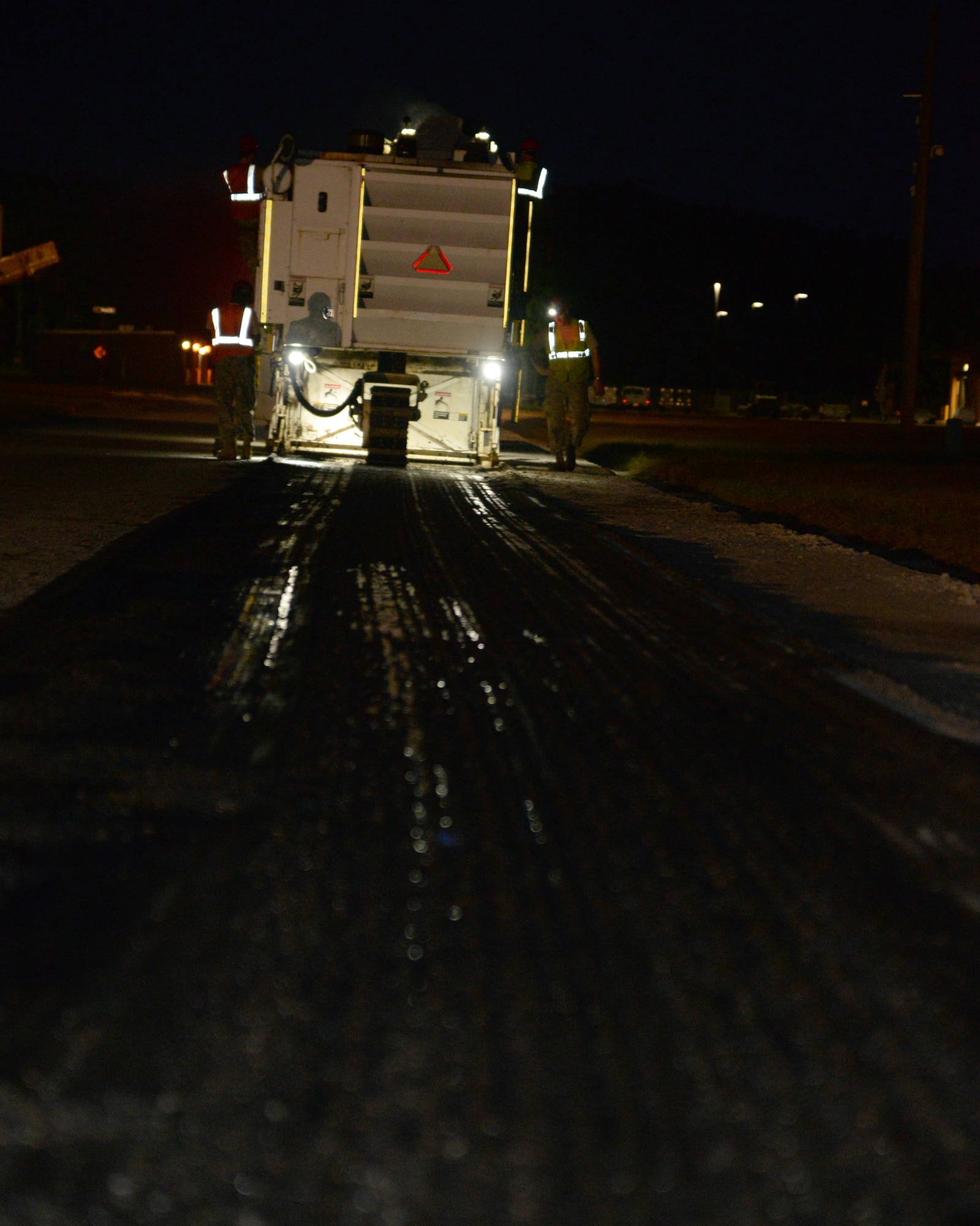 Airmen from the 823rd Rapid Engineer Deployable Heavy Operational Repair Squadron Engineers assigned to Hurlburt Field, Fla., mill a section of road in the 20th Equipment Maintenance Squadron munitions flight compound at Shaw Air Force Base, S.C., Sept. 2, 2014. The Roadtec RX-60C milling machine features an 8-foot drum equipped with 127 metal teeth to rip up the existing asphalt. (U.S. Air Force photo by Airman 1st Class Jonathan Bass/Released)