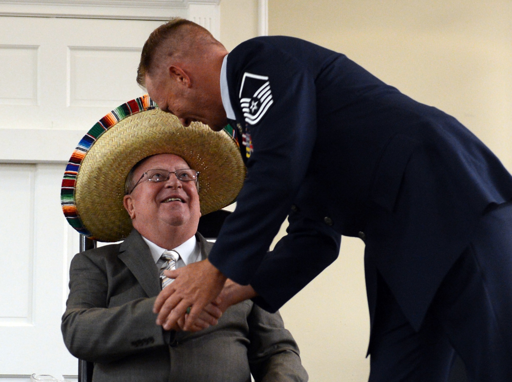 Retired U.S. Air Force Master Sgt. Bruce Pauly, 20th Logistics Readiness Squadron chief of passenger travel, shakes the hand of Master Sgt. Randy Dechant, 20th LRS deployment distribution superintendent, during Pauly’s retirement ceremony at the Carolina Skies Club and Conference Center, Shaw Air Force Base, S.C., Sept. 3, 2014. Pauly began serving in the Air Force in 1970, retiring as a master sergeant after 24 years. He then worked as a Department of Defense employee for 15 years. (U.S. Air Force photo by Senior Airman Tabatha Zarrella/Released)