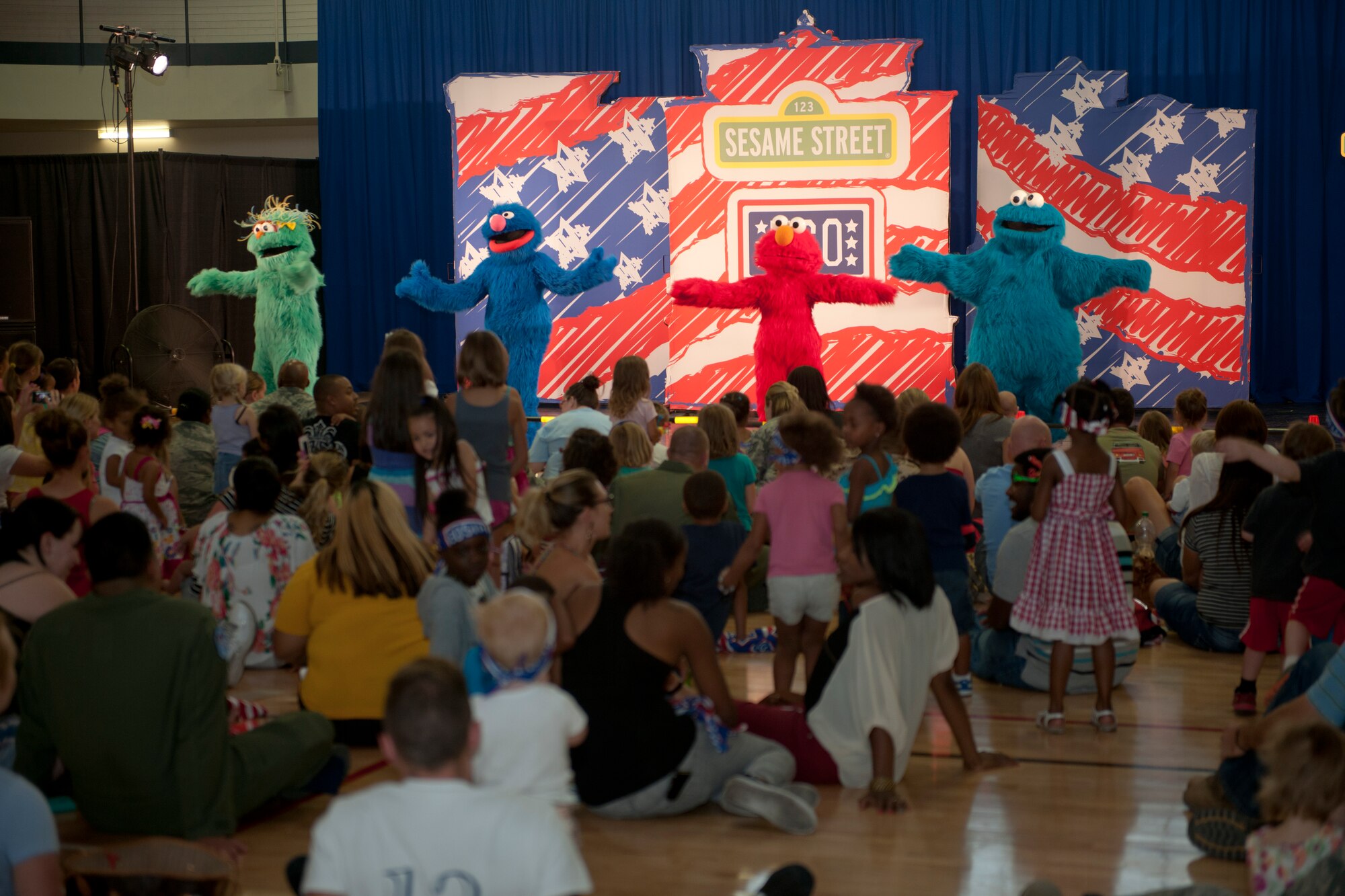 Characters from the popular children’s show, Sesame Street, perform for Team Holloman families Sept. 3, at Holloman Air Force Base, N.M. The United Service Organizations presented the Sesame Street/USO Experience for Military Families to help create lasting memories for service members and their families, while dealing with challenges of military life. The 30-minute show consisted of three songs where Sesame Street characters sang, danced and interacted with families in the audience. (U.S. Air Force photo by Airman 1st Class Emily A. Kenney/ Released)