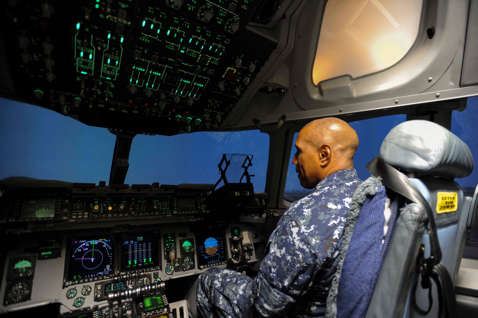 Navy Capt. Stanley Keeve, Jr., Joint Base Pearl Harbor-Hickam commander, prepares for a flight in the C-17 Globemaster III flight simulator as part of his immersion tour Sept. 4, 2014 at JBPHH. Keeve was briefed by 15th Wing leaders and visited numerous squadrons to become familiar with the wing mission and operations. (U.S. Air Force photo by 1st Lt. Andrea Dykes)