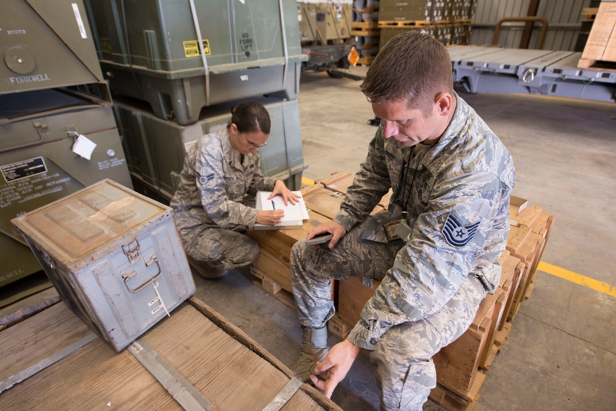 Airman 1st Class Hailey Frerichs, 366th Equipment Maintenance Squadron munitions operations crew member annotates information as Tech. Sgt. Benjamin Fritz, 366th Equipment Maintenance Squadron assistant NCO of precision guided munitions, counts the equipment Sept. 2, 2014, at Mountain Home Air Force Base, Idaho. Twice a year, Airmen from the 366th EMS carry out these inventories for precise accountability. (U.S. Air Force Photo by Airman 1st Class Malissa Lott/RELEASED)