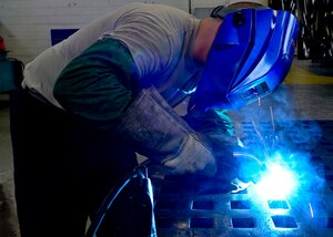 U.S. Air Force Senior Airman Spencer Chambers, 1st Maintenance Squadron aircraft metals technology journeyman, welds a piece of metal to manufacture parts for aircraft at Langley Air Force Base, Va., Sep. 3, 2014.  Chambers said he enjoys using various blue-prints to create parts to support units across the base.  (U.S. Air Force photo by Senior Airman Connor Estes/Released)
