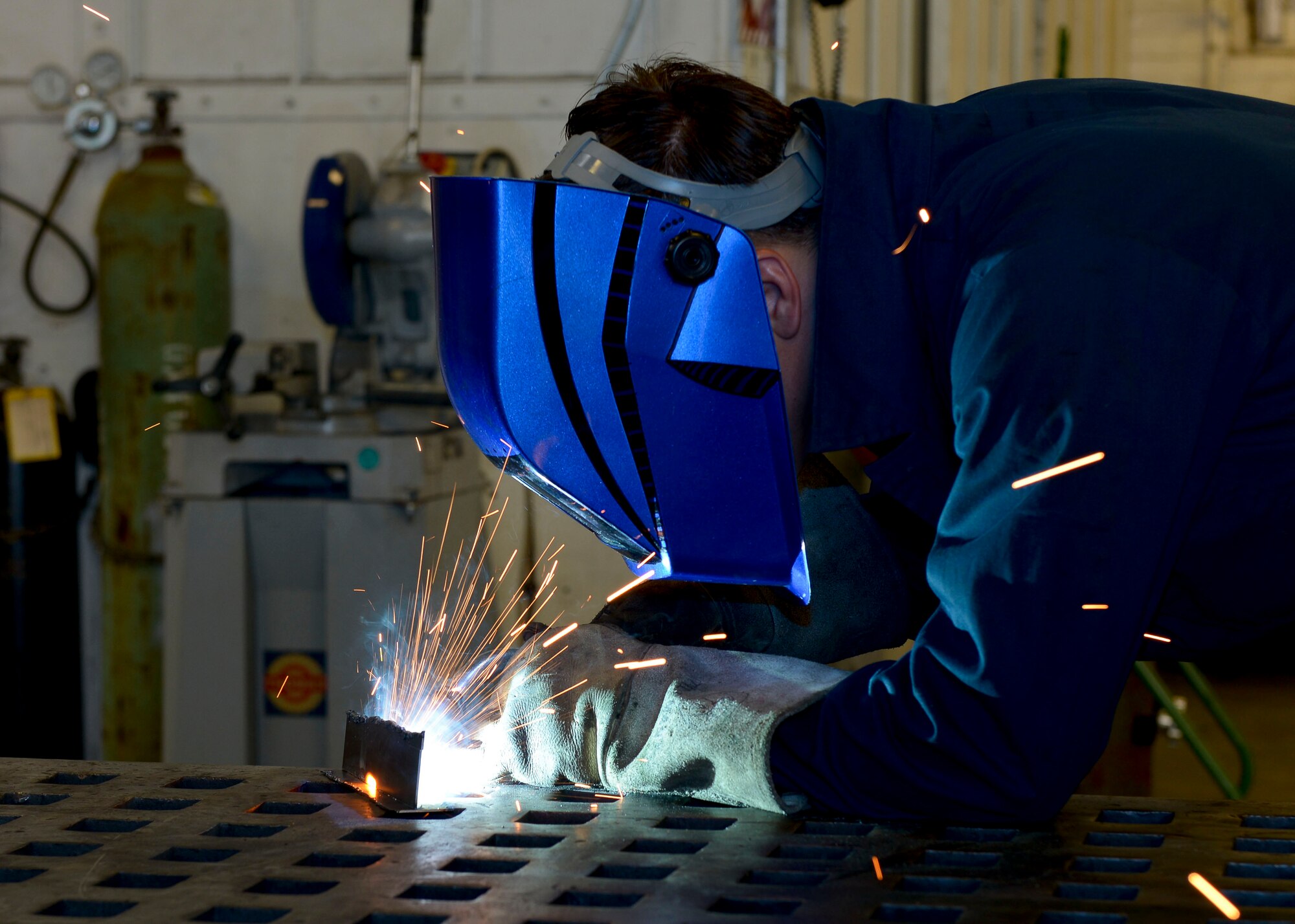 U.S. Air Force Senior Airman McKinley Smith, 1st Maintenance Squadron aircraft metals technology journeyman, welds together two metal plates at Langley Air Force Base, Va., Sep. 3, 2014.  Smith said he enjoys fabricating parts not only for aircraft, but for units base-wide. The sheet metals shop also performs corrosion prevention by sandblasting and painting parts in a hanger. (U.S. Air Force photo by Senior Airman Connor Estes/Released)