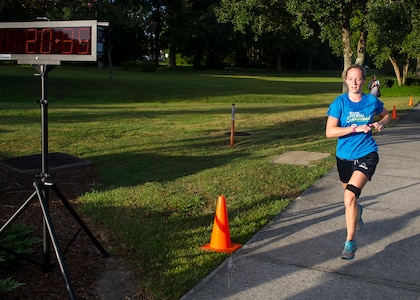 Jessica Ramsey, spouse of 2nd Lt. Philip Ramsey, 628th Civil Engineer Squadron, finishes the 5k Fitness Challenge Sept. 5, 2014, at Joint Base Charleston, S.C. Ramsey was the first female finisher with a time of 20:35 and won a duffel bag filled with fitness items. More than 200 people participated in the run.  (U.S. Air Force photo/Staff Sgt. William O'Brien)