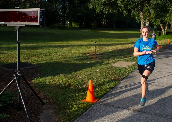 Jessica Ramsey, spouse of 2nd Lt. Philip Ramsey, 628th Civil Engineer Squadron, finishes the 5k Fitness Challenge Sept. 5, 2014, at Joint Base Charleston, S.C. Ramsey was the first female finisher with a time of 20:35 and won a duffel bag filled with fitness items. More than 200 people participated in the run.  (U.S. Air Force photo/Staff Sgt. William O'Brien)