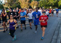 Members of Team Charleston sport athletic apparel of their favorite sports teams as they take place in the 5K fitness Challenge Sept. 5, 2014, at Joint Base Charleston, S.C. The Fitness Challenge is held monthly to test Team Charleston’s fitness abilities. In honor of the kickoff of football season, runners were encouraged to wear their favorite high school, college or professional sports team’s jersey or colors. (U.S. Air Force photo/Staff Sgt. William O'Brien)