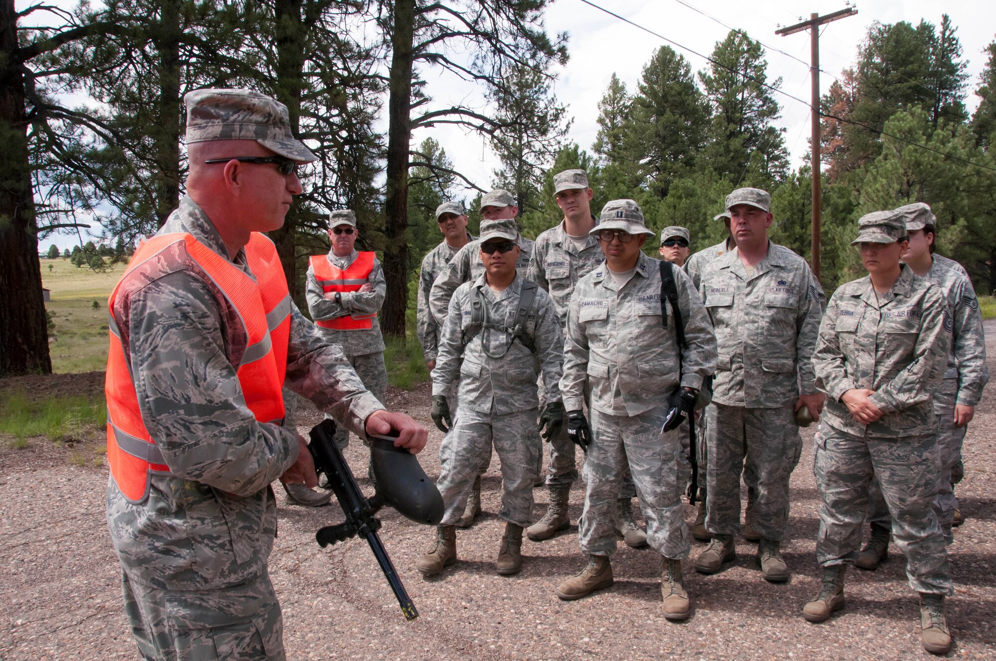 Lt. Col. Gregory Bliss instructs 162nd Wing members on the proper use of a paintball gun prior to beginning the care-under-fire exercise during the final day of training at the Camp Navajo Collective Training Center Aug. 11-15. (U.S. Air National Guard photo by 2nd Lt. Lacey Roberts)