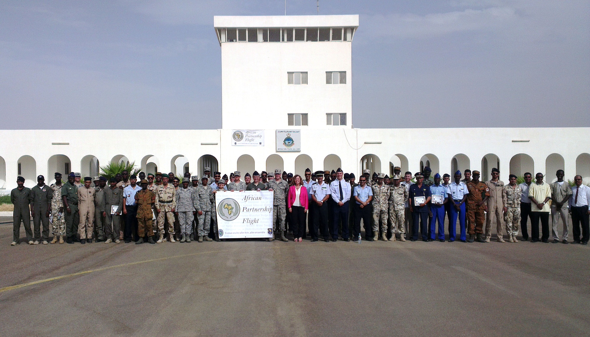A total of 17 U.S. Airmen from U.S. Air Forces Europe and Air Forces Africa and Air Mobility Command as well as more than 55 airmen from African partner nations pose for a group photo with U.S. and Mauritanian dignitaries Sept. 4, 2014, outside the schoolhouse on Atar Airbase, Mauritania, following the conclusion of African Partnership Flight Mauritania.  The U.S. Air Force and the Mauritanian government co-hosted this APF, which involved Airmen from the U.S. and six African countries including Mauritania, Niger, Burkina Faso, Mali, Senegal and Tunisia.  (U.S. Air Force photo/Master Sgt. Brian Boisvert/Released)