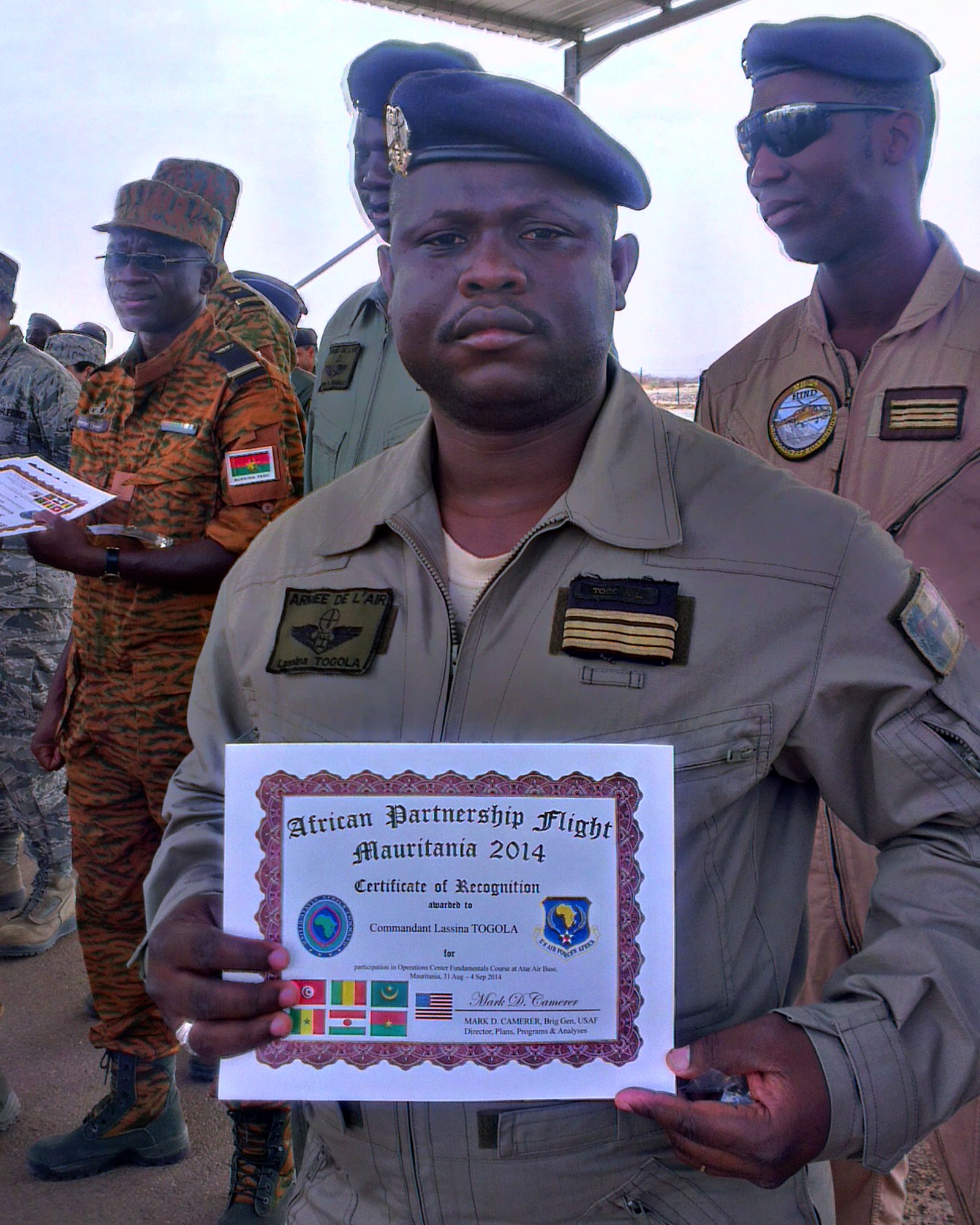 A Mali Airman proudly displayes his African Partnership Flight Mauritania graduation certificate Sept. 4, 2014, at Atar Airbase in Mauritania, after completeing a week-long training event about ground and flight safety; Intelligence, Surveillance and Reconnaissance; and command operations. Six African nations came together in Atar, Mauritania, to learn from each other and build partnerships as part of African Partnership Flight Mauritania. (U.S. Air Force photo/Master Sgt. Brian Boisvert/Released)