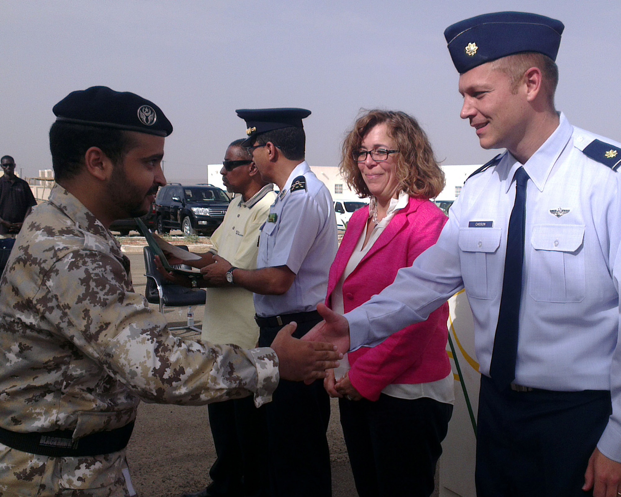 A proud Mauritanian Airman goes through the congratulatory receiving line and shakes hands with Col. Mohammad Lehreitani, Mauritania Air Force chief in command, center; Martha Patterson, Charge d’Affaires, U.S. Embassy in Mauritania, center right; and U.S. Air Force Maj. Hartmut Casson, APF Mauritania mission commander, right; after receiving his certificate of completion Sept. 4, 2014, at Atar Airbase in Mauritania, following a week-long military classroom training event. The topics discussed consisted of ground and flight safety; Intelligence, Surveillance and Reconnaissance; and command operations.  The training concluded with the Mauritanian Air Force performing a live demonstration of ISR techniques. (U.S. Air Force photo/Master Sgt. Brian Boisvert/Released)