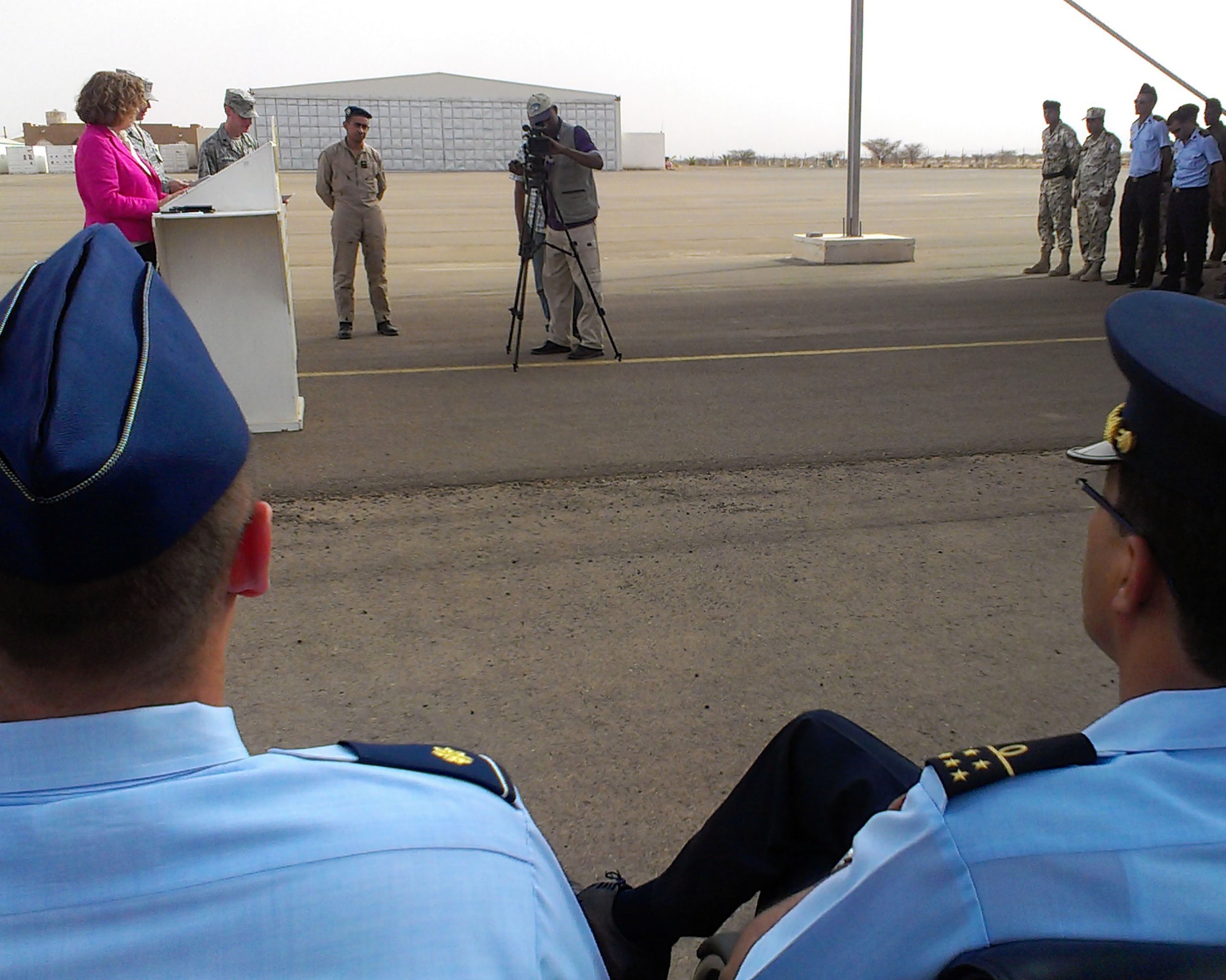 Martha Patterson, Charge d’Affaires, U.S. Embassy in Mauritania, delivers a congratulatory speech to students while U.S. Air Force Maj. Hartmut Casson, African Partnership Flight Mauritania mission commander, left; and Col. Mohammad Lehreitani, Mauritania Air Force chief in command, listen prior to handing out course completion certificates Sept. 4, 2014, at Atar Airbase in Mauritania. APF brought six African nations together for a week-long exchange of ideas with African air forces. (U.S. Air Force photo/Master Sgt. Brian Boisvert/Released)
