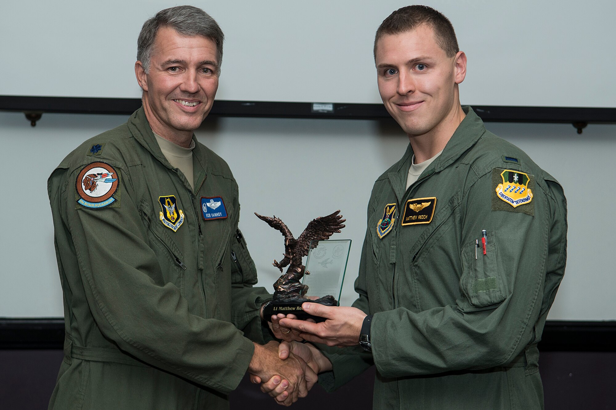 U.S. Air Force Lt. Col. Robert VanHoy, 93rd Bomb Squadron commander, presents the Lindell Mabus Leadership Award to 1st Lt. Matthew Reoch during a Formal Training Unit graduation ceremon, Aug. 28, 2014, Barksdale Air Force Base, La. Reoch was selected by his fellow class members for his exceptional leadership, which was critical to the class's graduation. (U.S. Air Force photo by Master Sgt. Greg Steele/Released)