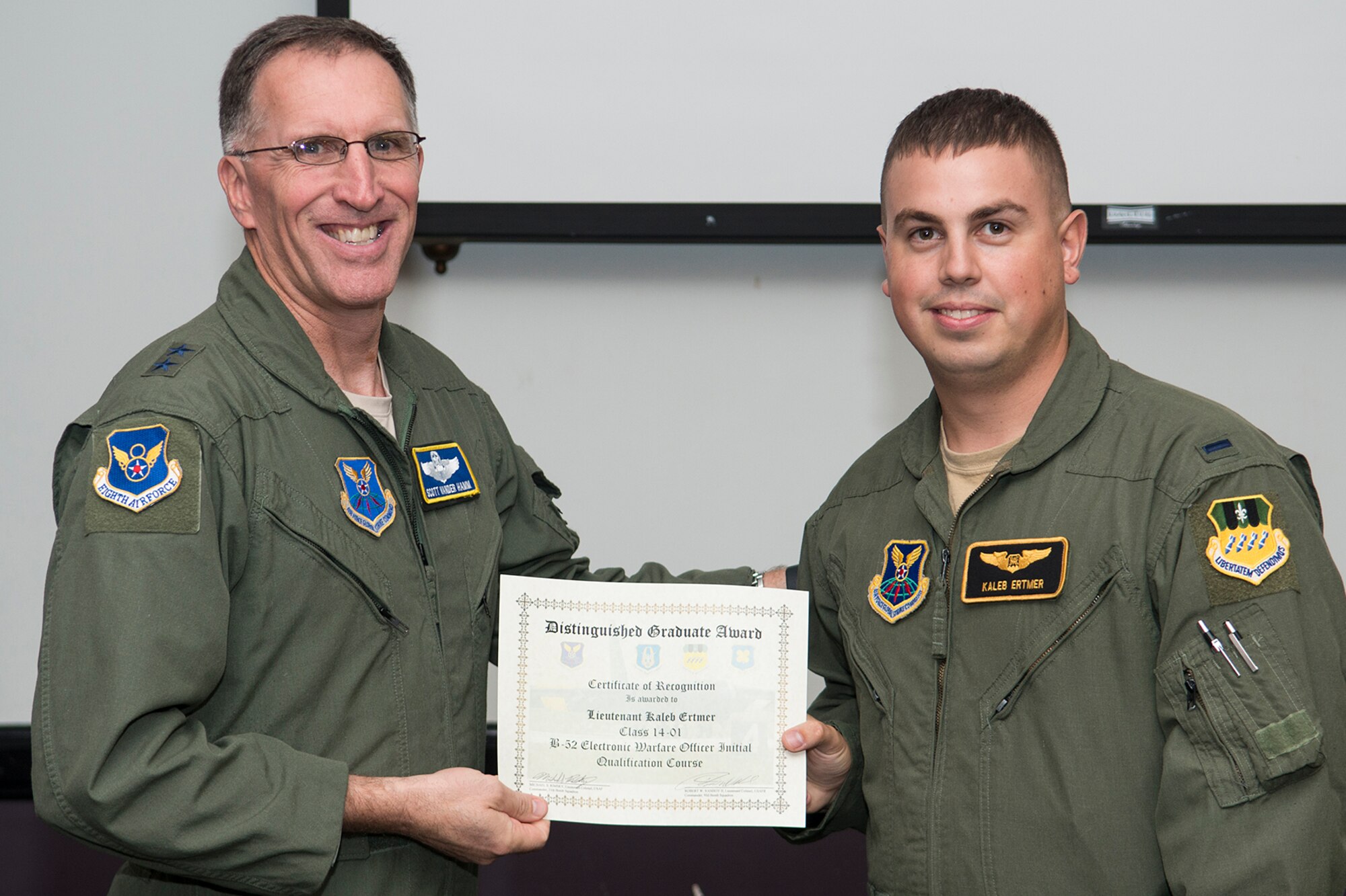 U.S. Air Force Maj. Gen. Scott Vander Hamm, Eighth Air Force commander, presents the Distinguished Graduate Award to 1st Lt. Kaleb Ertmer during a Formal Training Unit (FTU) graduation ceremony, Aug. 28, 2014, Barksdale Air Force Base, La. Ertmer graduated from the FTU as an electronic weapons officer on the B-52H Stratofortress. (U.S. Air Force photo by Master Sgt. Greg Steele/Released)