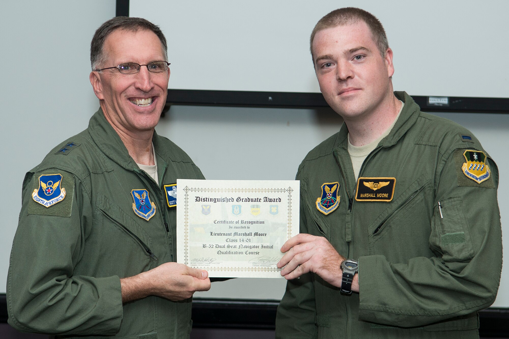 U.S. Air Force Maj. Gen. Scott Vander Hamm, Eighth Air Force commander, presents the Distinguished Graduate Award to 1st Lt. Marshall Moore during a Formal Training Unit (FTU) graduation ceremony, Aug. 28, 2014, Barksdale Air Force Base, La. Moore graduated from the FTU as a navigator on the B-52H Stratofortress. (U.S. Air Force photo by Master Sgt. Greg Steele/Released)