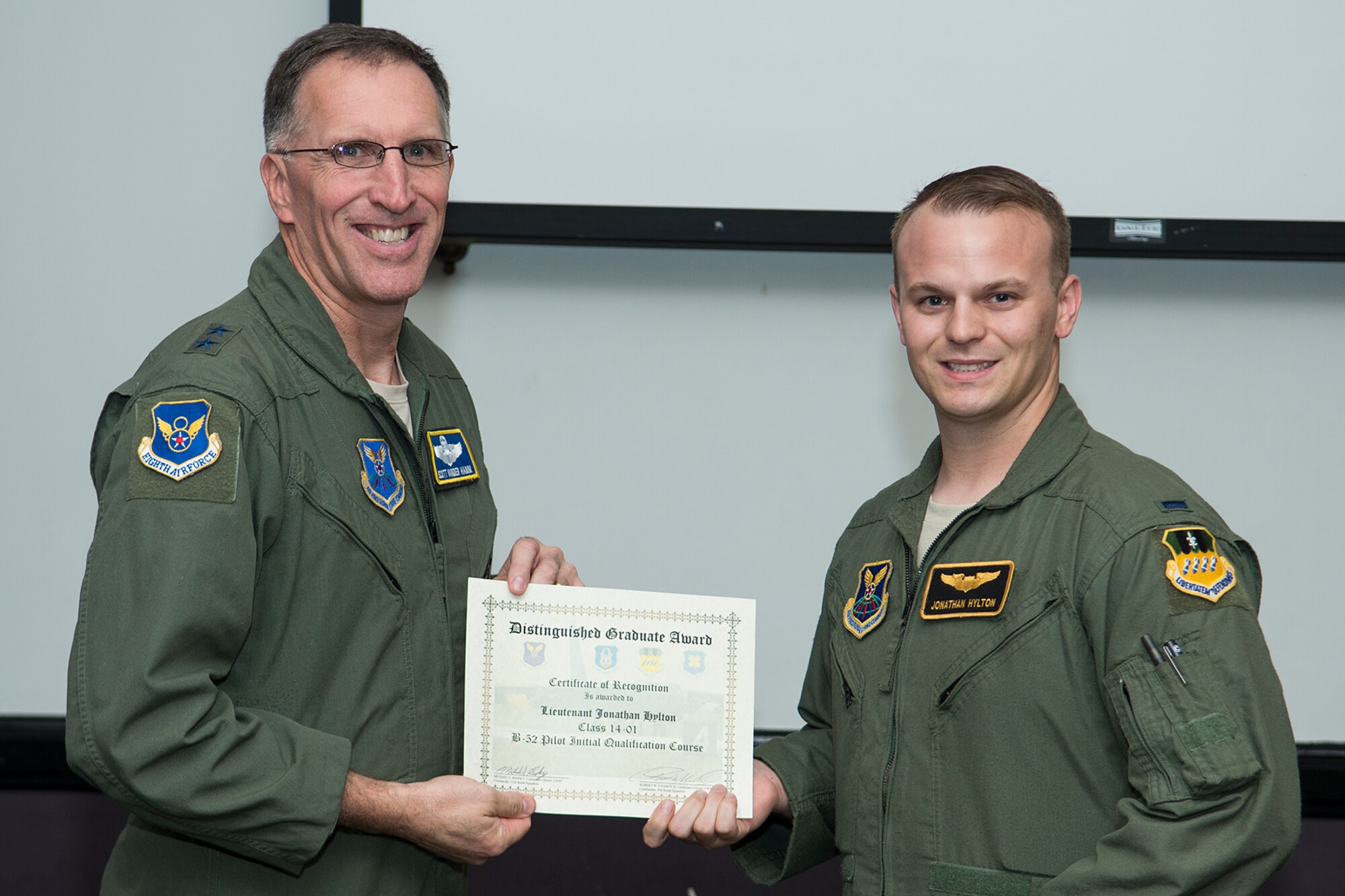 U.S. Air Force Maj. Gen. Scott Vander Hamm, Eighth Air Force commander, presents the Distinguished Graduate Award to 1st Lt. Jonathan Hylton during a Formal Training Unit (FTU) graduation ceremony, Aug. 28, 2014, Barksdale Air Force Base, La. Hylton graduated from the FTU as a pilot on the B-52H Stratofortress. (U.S. Air Force photo by Master Sgt. Greg Steele/Released)