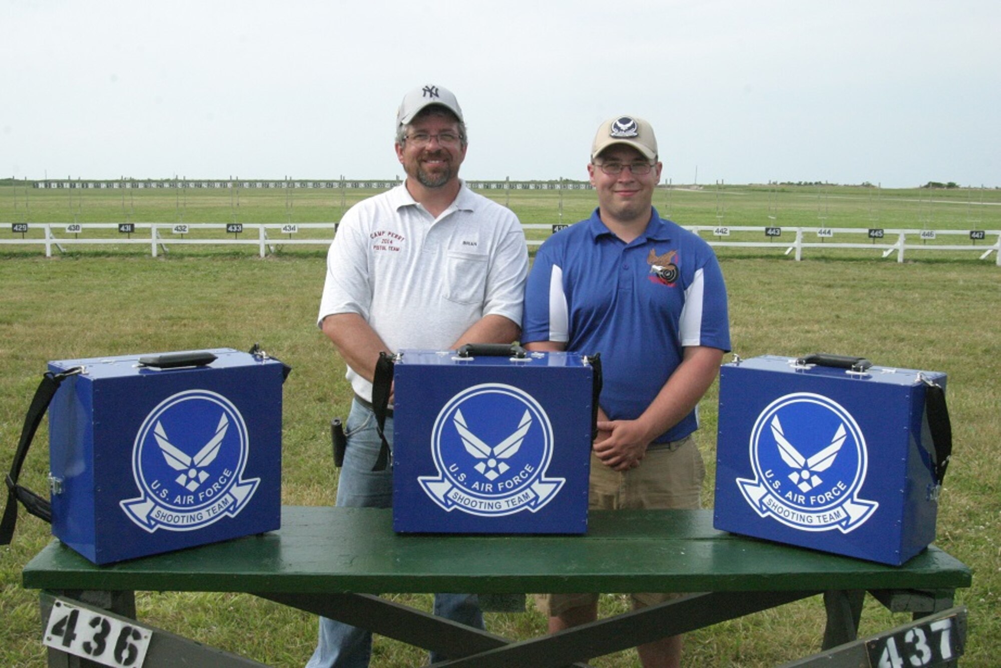 Brain Mallette and his son, U.S. Air Force Staff Sgt. Richard Mallette, 55th Maintenance Squadron aerospace ground equipment craftsman, pose for a photo at Camp Perry, Ohio after National Matches. His son is a member of the Air Force National Pistol Team. (Courtesy photo) 