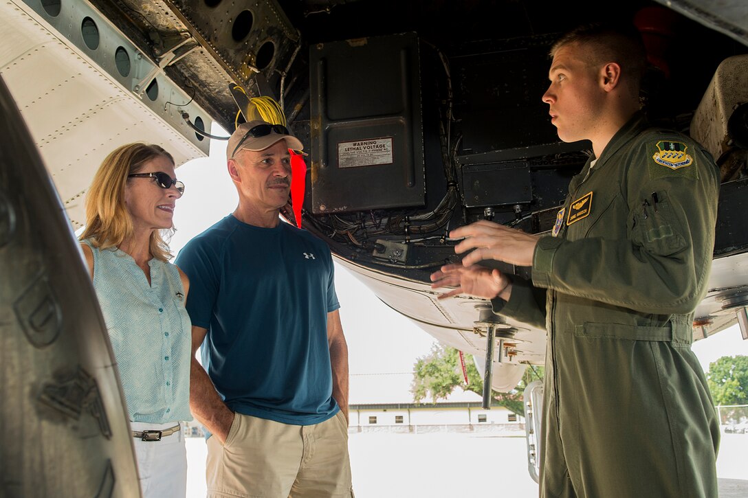 U.S. Air Force 1st Lt. Daniel Harrison talks to family members about the capabilities of the B-52H Stratofortress during a tour on Aug. 28, 2014, Barksdale Air Force Base, La. Harrison is a student of the Formal Training Unit class 14-01 and has spent the last six months at Barksdale learning to fly the B-52. (U.S. Air Force photo by Master Sgt. Greg Steele/Released)