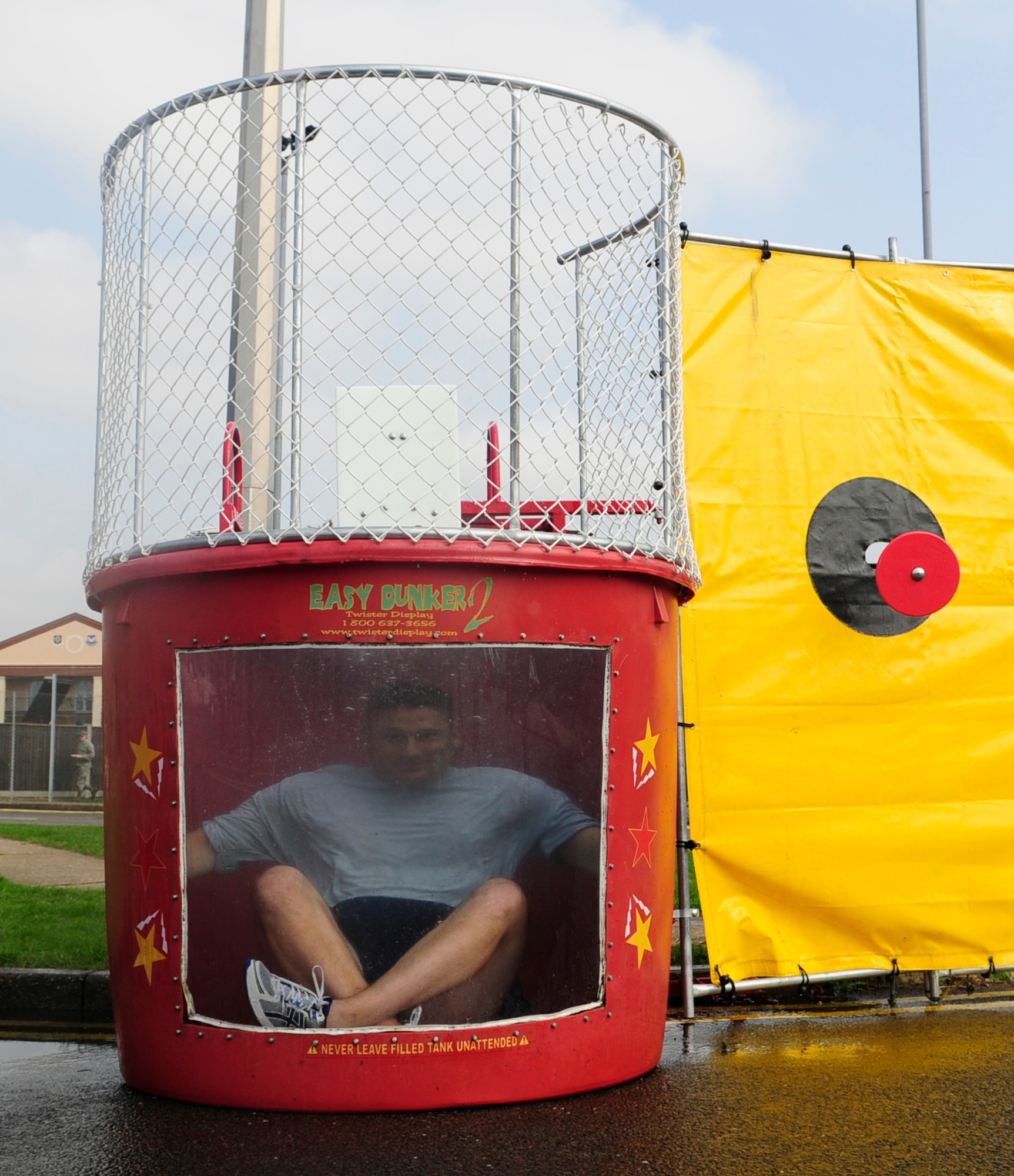 U.S. Air Force Chief Master Sgt. Tracy Jones, 100th Air Refueling Wing command chief, pauses for a second underwater after getting plunged into the dunk tank Sept. 5, 2014, at the Unaccompanied Airmen’s Appreciation Day on RAF Mildenhall, England. First sergeants, members of the Top Three Council and Chiefs Group organized the fourth annual UAAD to show their appreciation for the hard work done by Team Mildenhall Airmen. (U.S. Air Force photo/Airman 1st Class Preston D. Webb/Released)