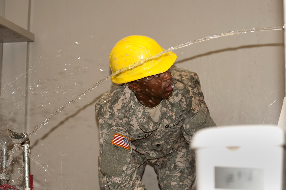 Army Spc. Keuly Yemele, student at 366th Training Squadron, was identifying leaks during the water and fuel systems maintenance course Sept. 2, 2014. The block instructors placed various troubles in the student plumbing systems that they have been constructing since Block 1, and they construct entire plumbing systems for a bathroom from “rough-in” to finish plumbing.  The final objective before taking the block test is to troubleshoot the plumbing systems and make repairs so that there are no leaks and all fixtures operate properly. (U.S. Air Force Photo Danny Webb/Released)