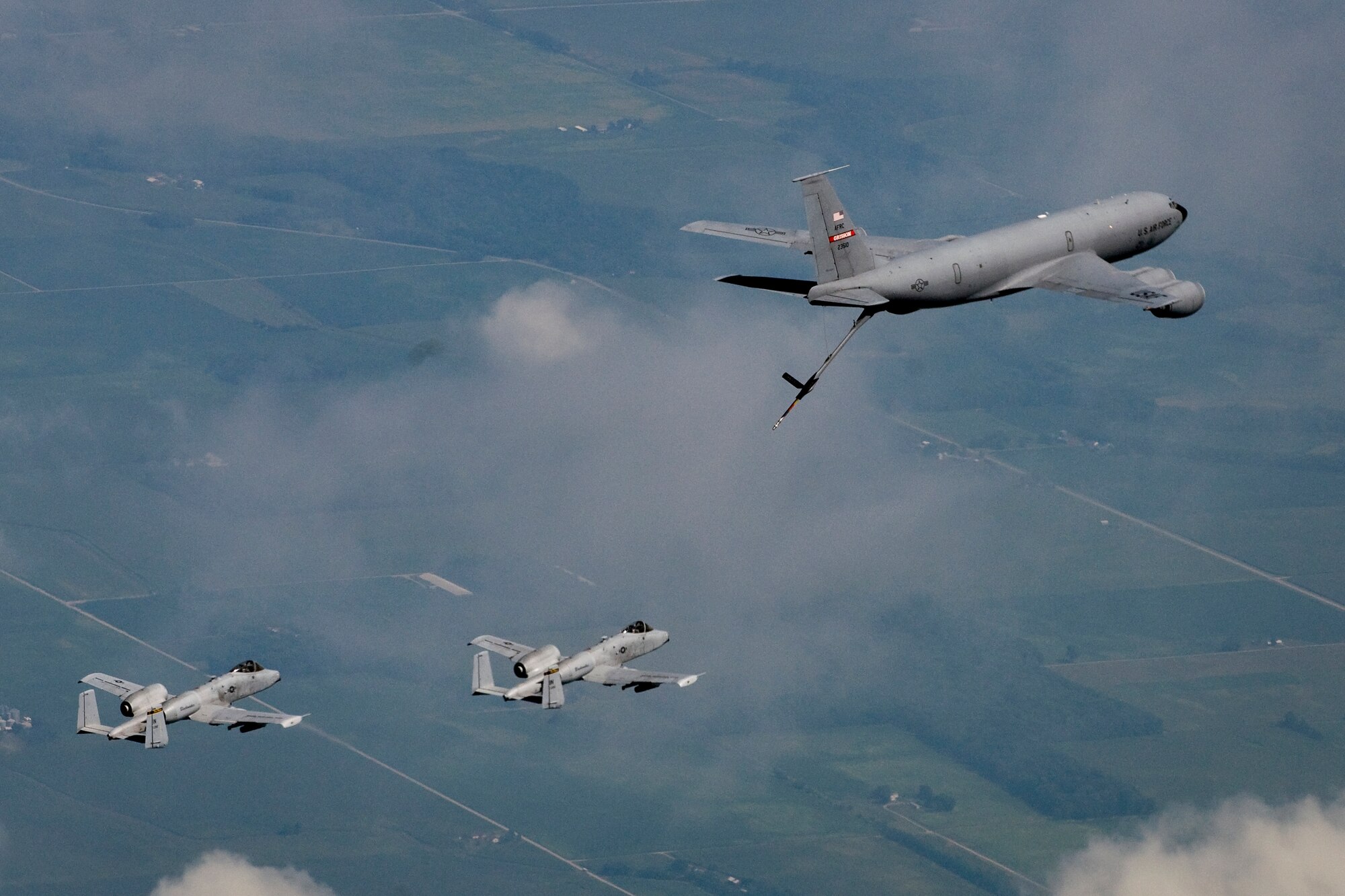 Two A-10 Thunderbolt II aircraft from the Air National Guard's 122nd Fighter Wing in Fort Wayne, Ind., fly behind a KC-135R Stratotanker aircraft from the Air Force Reserve's 434th Air Refueling Wing at Grissom Air Reserve Base, Ind., during a refueling mission over the Hoosier state Aug. 20, 2014. Indiana's two flying wings partnered together to fly 37 employers of guardsmen and reservists on a boss lift aimed at educating them about their employees' military service and responsibilities. (U.S. Air Force photo/Tech. Sgt. Mark R. W. Orders-Woempner) 
