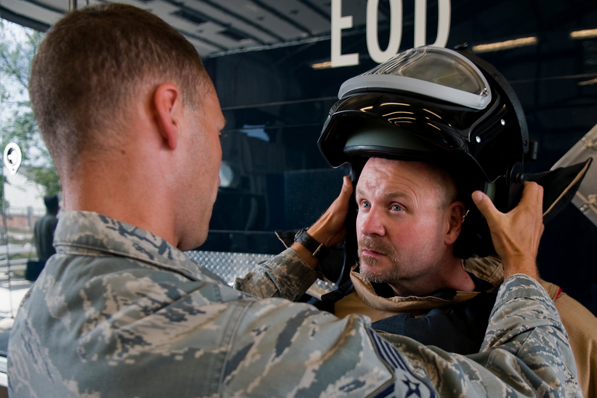 Staff Sgt. Timothy Strader, 434th Civil Engineer Squadron explosive ordnance disposal technician, puts a bomb suit helmet on Lee Corder, a supervisor with Butler Tech, during a tour for reserve component employers at Grissom Air Reserve Base, Ind., Aug. 19, 2014. Indiana's two flying wings partnered together to fly 37 employers of guardsmen and reservists on a boss lift aimed at educating them about their employees' military service and responsibilities. (U.S. Air Force photo/Tech. Sgt. Mark R. W. Orders-Woempner) 
