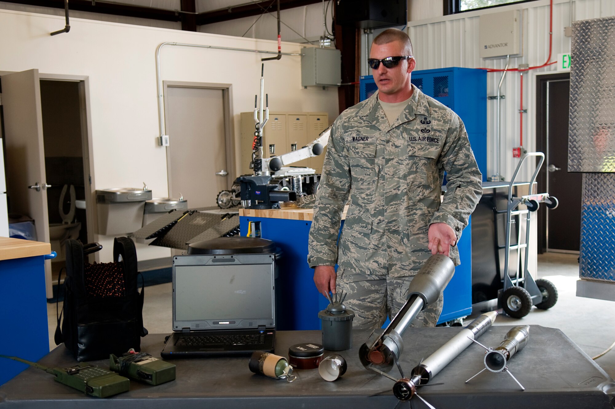 Tech. Sgt. Benjamin Wagner, 434th Civil Engineer Squadron explosive ordnance disposal training noncommissioned officer in charge, talks about the different types of military munitions an Air Force EOD team can dispose of during a tour for reserve component employers at Grissom Air Reserve Base, Ind., Aug. 19, 2014. Indiana's two flying wings partnered together to fly 37 employers of guardsmen and reservists on a boss lift aimed at educating them about their employees' military service and responsibilities. (U.S. Air Force photo/Tech. Sgt. Mark R. W. Orders-Woempner) 
