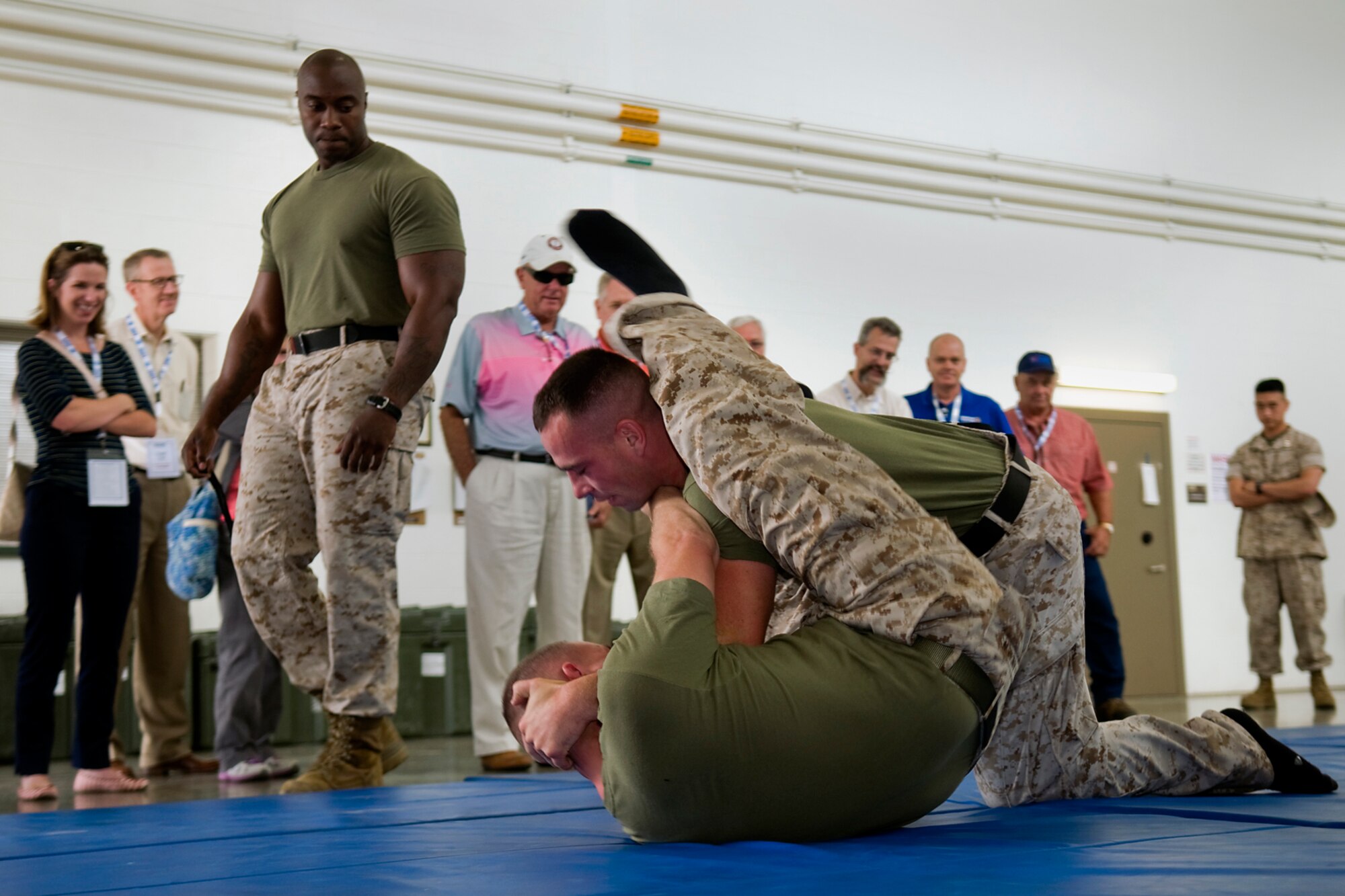 Marine Gunnery Sgt. Korey Wright, Detachment One, Communication Company, Combat Logistics Regiment 45, 4th Marine Logistics Group martial arts instructor, coaches two fellow marines during a training demonstration as reserve component employers  watch during a tour at Grissom Air Reserve Base, Ind., Aug. 19, 2014. Indiana's two flying wings partnered together with Grissom's Army Reserve and Marine Corps Reserve units to showcase the reserve components to 37 employers of guardsmen and reservists. (U.S. Air Force photo/Tech. Sgt. Mark R. W. Orders-Woempner) 
