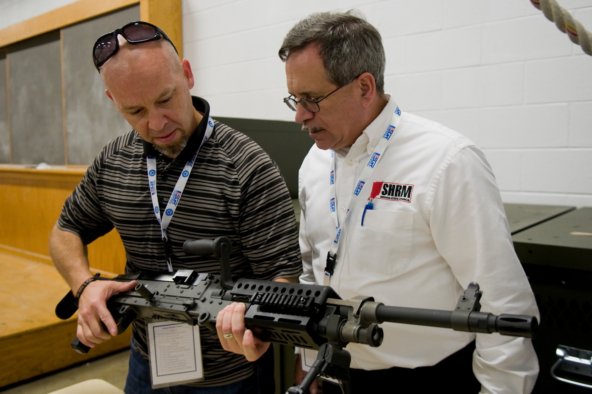 Chris Payton, Western Veterinary Clinic veterinarian, left, and Christopher Schrader, Schrader and Associates president, examine an Army Reserve M-240B light machine gun during a tour at Grissom Air Reserve Base, Ind., Aug. 19, 2014. Indiana's two flying wings partnered together with Grissom's Army Reserve and Marine Corps Reserve units to showcase the reserve components to 37 employers of guardsmen and reservists. (U.S. Air Force photo/Tech. Sgt. Mark R. W. Orders-Woempner) 
