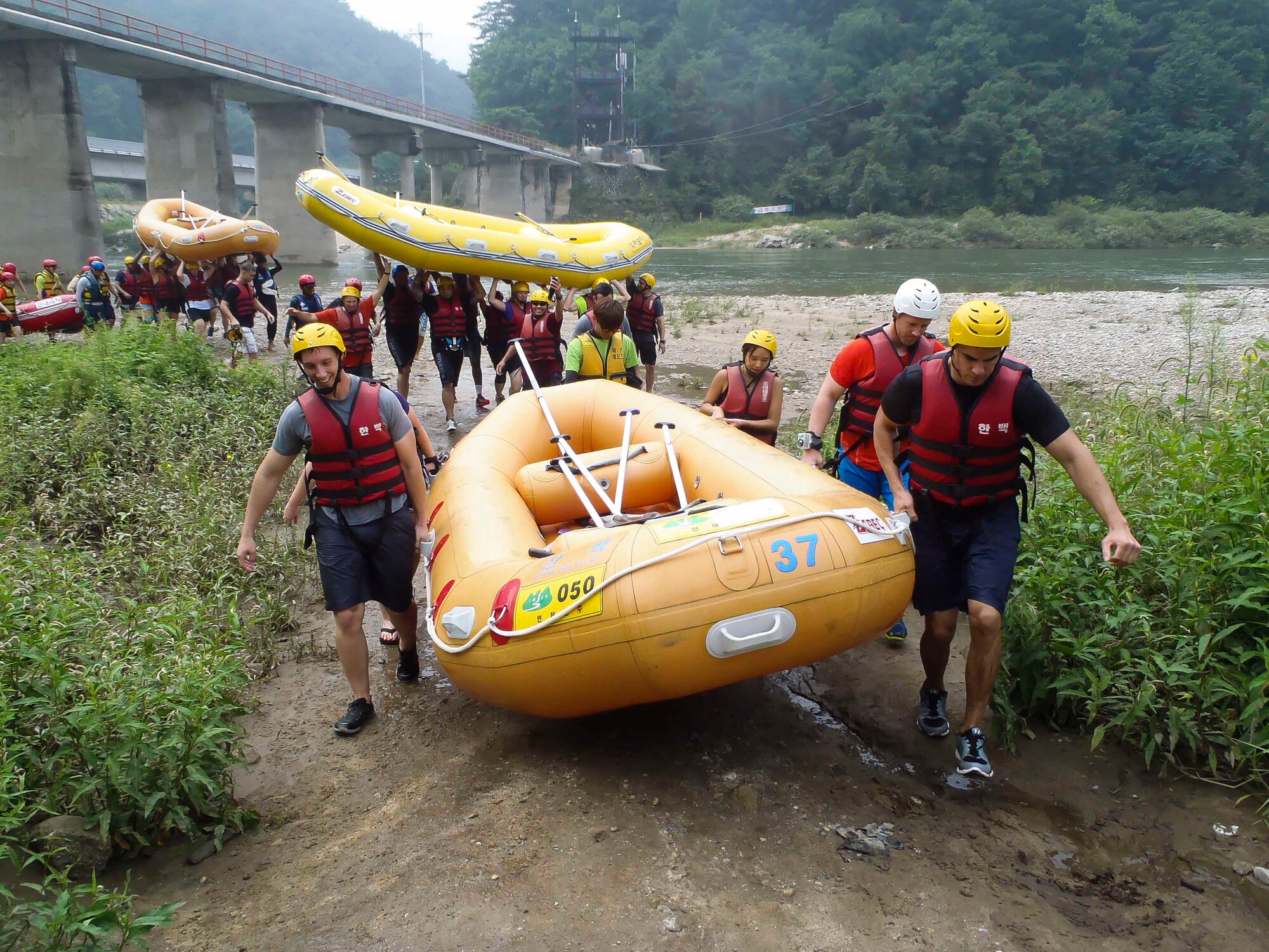 Airmen carry rafts after completing a water rafting trip on the Naerincheon River, Republic of Korea, Aug. 23, 2014. The stream stretches over 6 kilometers from Wondaegyo to the Gosari Resting Spot. (U.S. Air Force photo/Senior Airman David Owsianka)