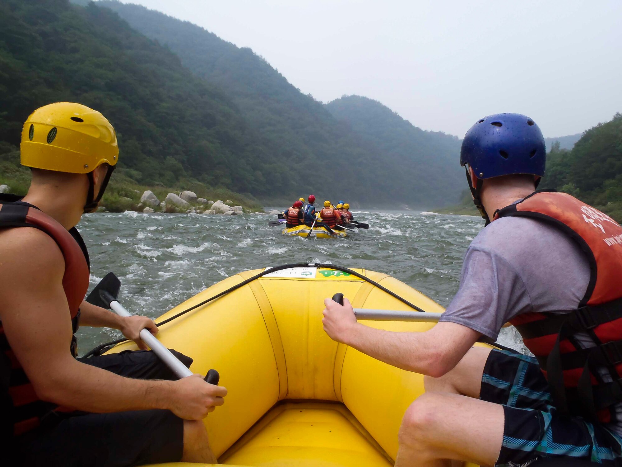 Airmen look down the river as they prepare to paddle down rapids during a water rafting trip on the Naerincheon River, Republic of Korea, Aug. 23, 2014. The water in the stream ricochets off stones and creates a combination of high, rough rapids and smooth, gentle currents. (U.S. Air Force photo/Senior Airman David Owsianka)